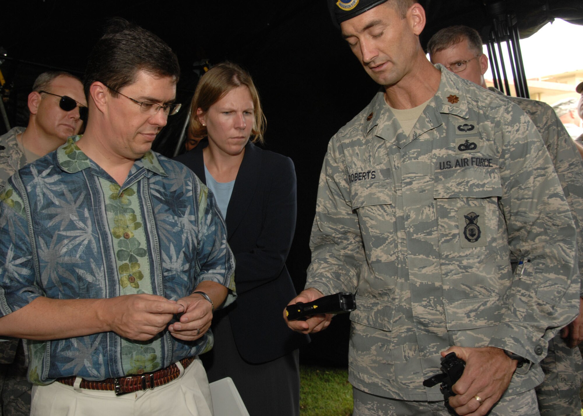 Major Troy Roberts 736th Security Forces Squadron, commander demonstrates some of the squadrons many weapons capabilities to the Deputy Assistant Secretary of Defense for Policy Planning Dr. Thomas Mahnken October 3 here. Dr. Mahnken is responsible for the major strategic planning functions within the office of the Secretary of Defense. The 36th Contingency Response Group held a demonstration that previewed the capabilities of each squadron. (U.S. Air Force photo by Airman 1st Class Nichelle Griffiths)