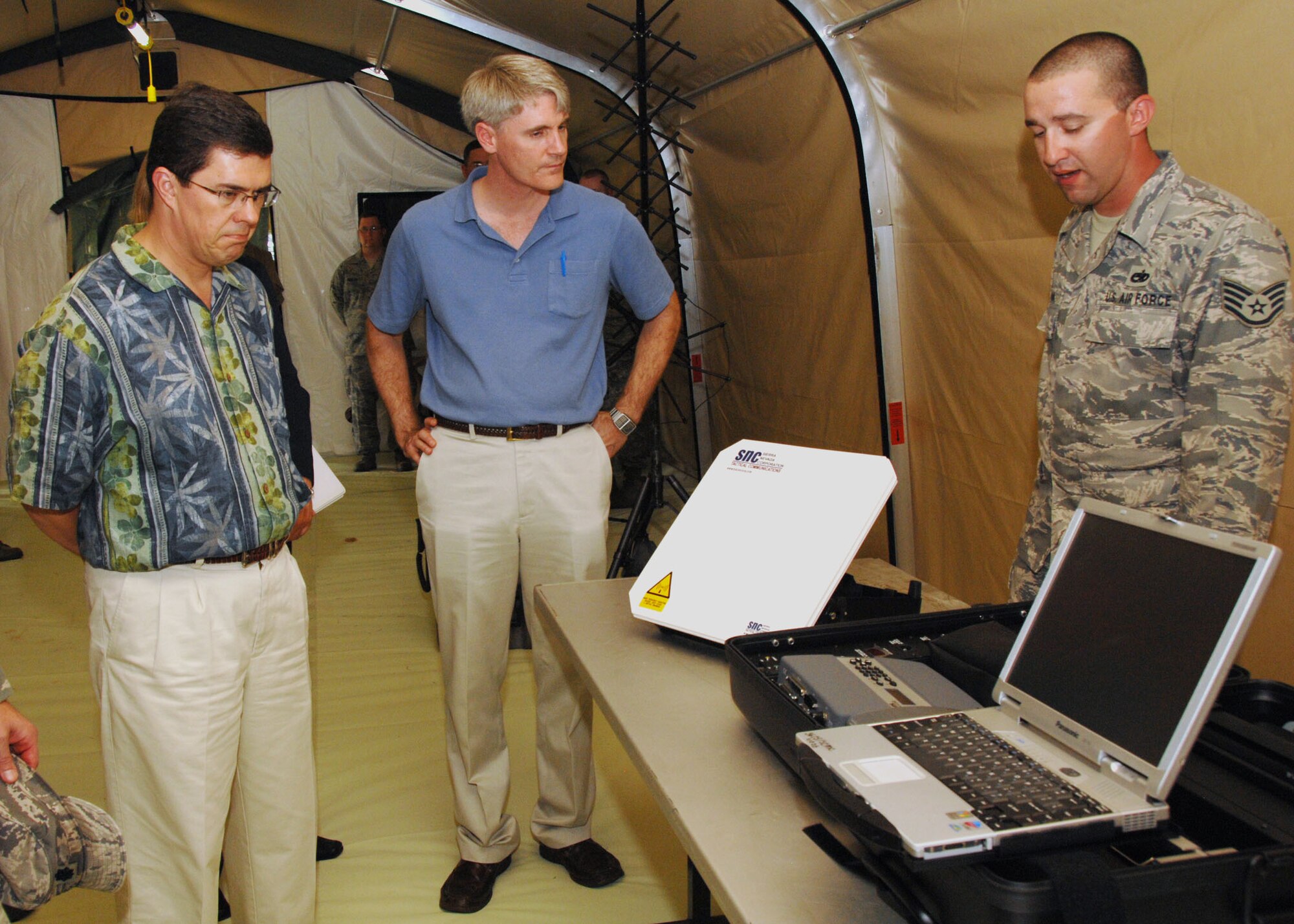 ANDERSEN AIR FORCE BASE, Guam - Staff Sgt. Stephen Santana, 644th Combat Communications Squadron, explains types of equipment used while deployed to Dr. Thomas Mahnken, Deputy Assistant Secretary of Defense for Policy Planning, Oct. 3. Dr. Mahnken attended a demonstration highlighting the capabilities of the 36th Contingency Response Group. Each squadron set up static displays to show off what they bring to the fight. (U.S. Air Force photo by Airman 1st Class Nichelle Griffiths)