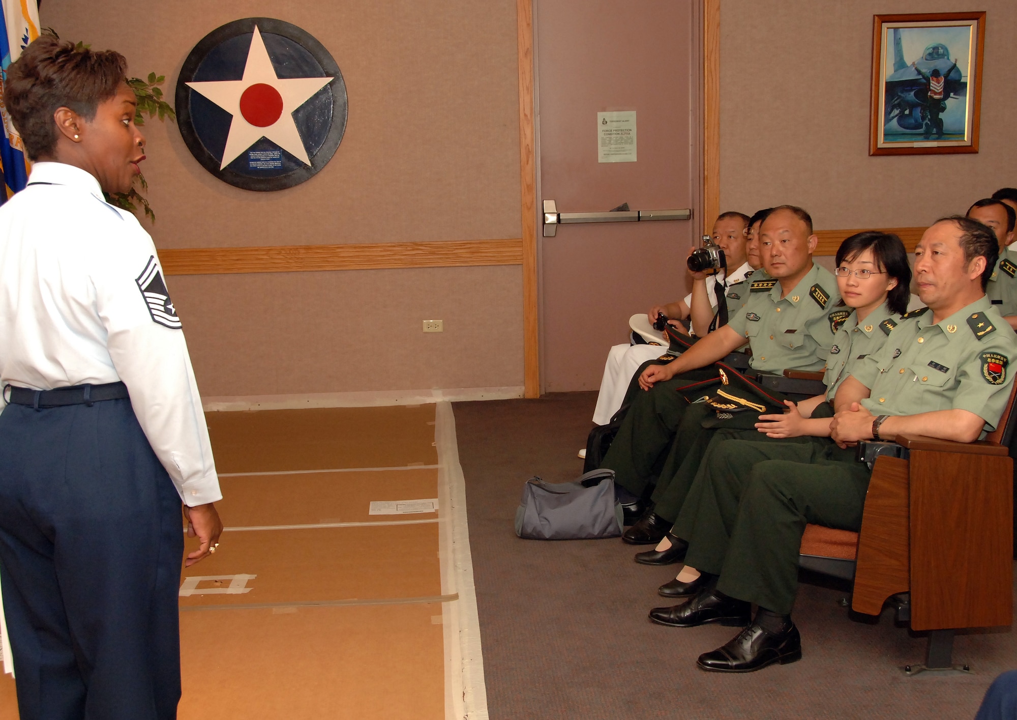 HICKAM AIR FORCE BASE, Hawaii-- Senior Master Sgt. Vanessa Smallsbryan, director of education for the Hickam Professional Military Edcuation Center, provided a brief on Airman Leadership school to give China's People Liberation Army Maj. Gen.Zhong Zhiming and his delegation, a better understanding of the importance of training and education for Airmen. The visit is part of a continuum of reciprocal exchanges between the United States and China and contributing to the steady progress of our military-to-military relationship-building activities. (U.S. Air Force photo by Vanessa Perez)