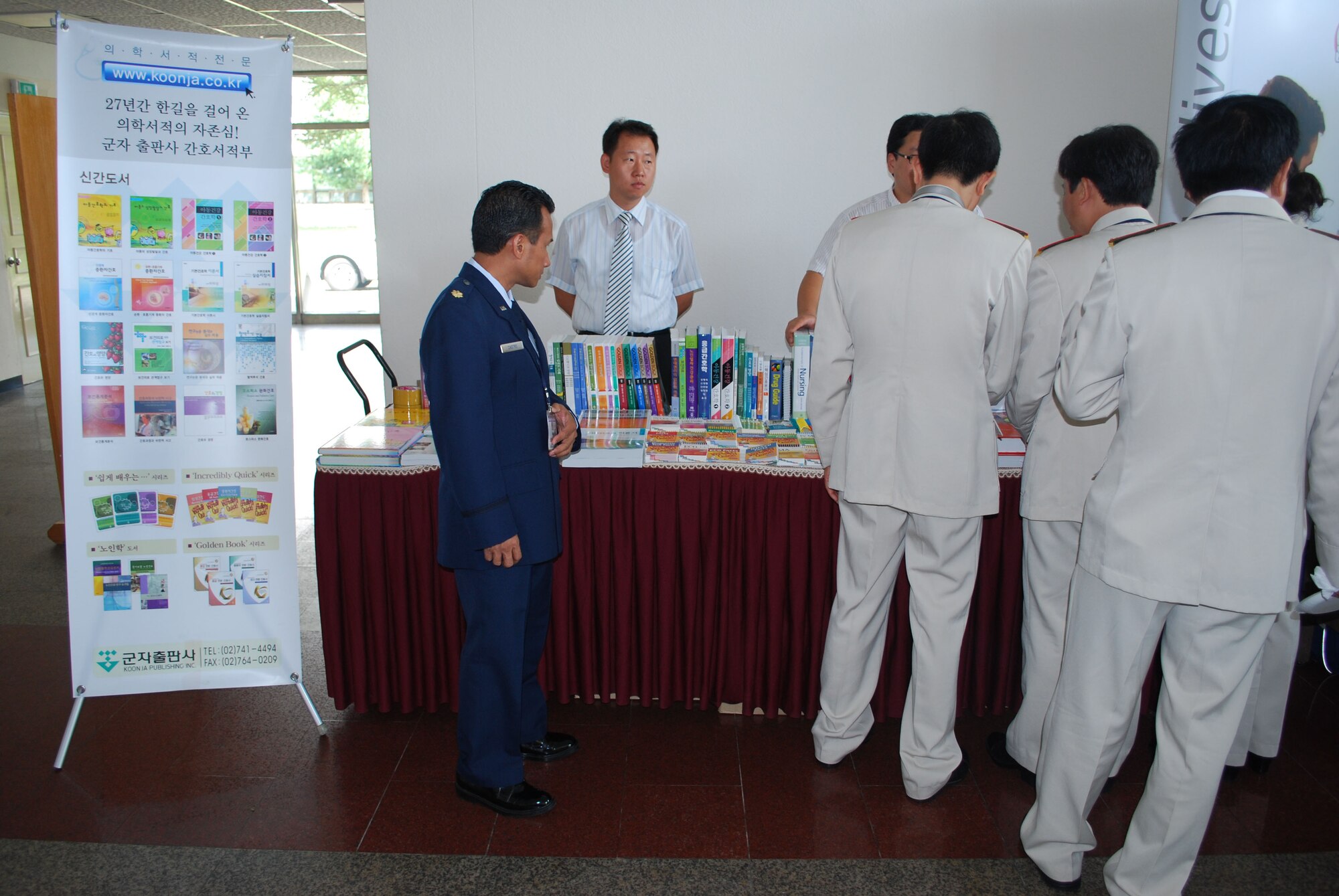 Maj. Edilbert Castro, Air Force Reserve 624th Aeromedical Staging Squadron, examines nursing displays set out during the second annual Asia Pacific  Military Nursing Conference. Major Castro was one of more than 40 Air Force, Army and Navy nurses and medical professionals who attended the conference with attendees from seven countries Sept. 1-5 at the Korea Armed Forces Nursing Academy in Daejeon, Republic of Korea. The 624th ASTS is part of the 624th Regional Support Group, Hickam Air Force Base, Hawaii.