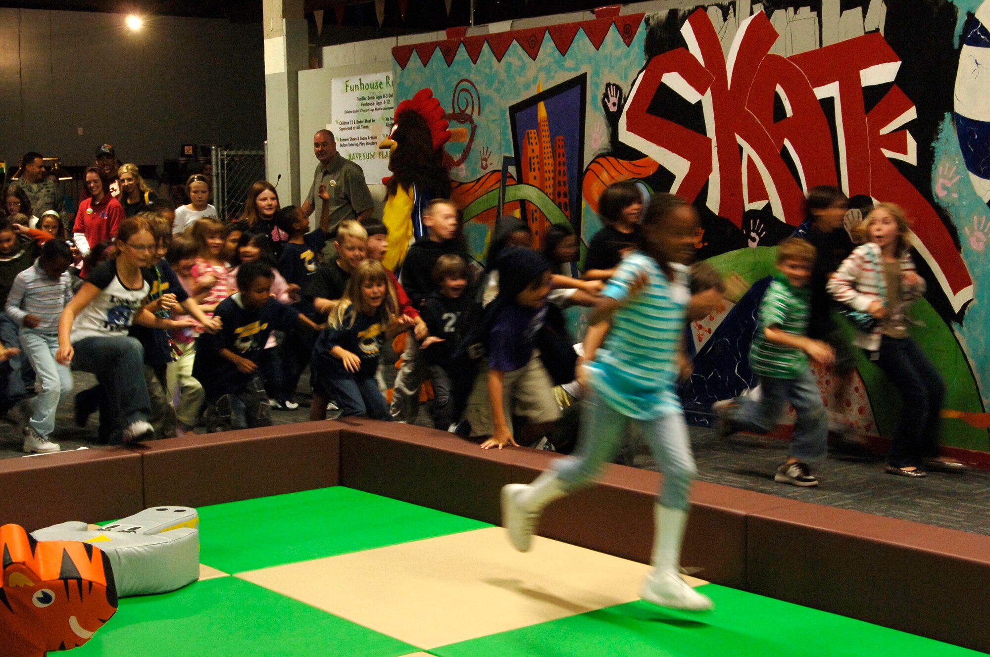 FAIRCHILD AIR FORCE BASE, Wash. – Children race to explore the new Toddler Zone and Funhouse during the grand opening Sept. 26. The area between the skating rink and batting cages in the FunSpot now includes two separate play areas; one for toddlers only, and the other for ages 4 to 12. (U.S. Air Force photo / Airmen 1st Class Melissa Barnett)