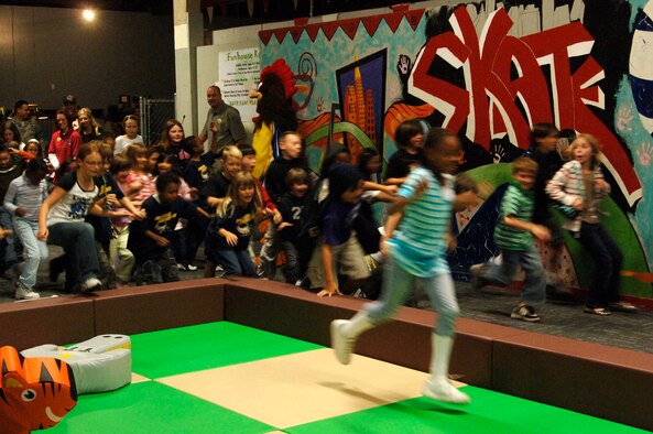 FAIRCHILD AIR FORCE BASE, Wash. – Children race to explore the new Toddler Zone and Funhouse during the grand opening Sept. 26. The area between the skating rink and batting cages in the FunSpot now includes two separate play areas; one for toddlers only, and the other for ages 4 to 12. (U.S. Air Force photo / Airmen 1st Class Melissa Barnett)