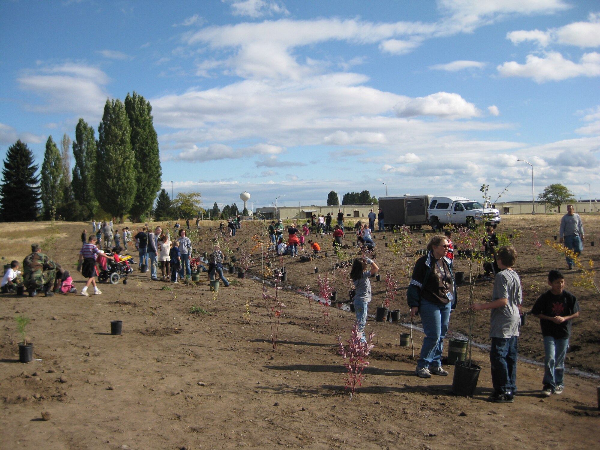 FAIRCHILD AIR FORCE BASE, Wash. – Children from Michael Anderson Elementary eagerly get down and dirty, helping to plant more than 600 trees and shrubs, joining in the celebration of National Public Lands Day Sept. 25. (U.S. Air Force photo / Mary Farver)