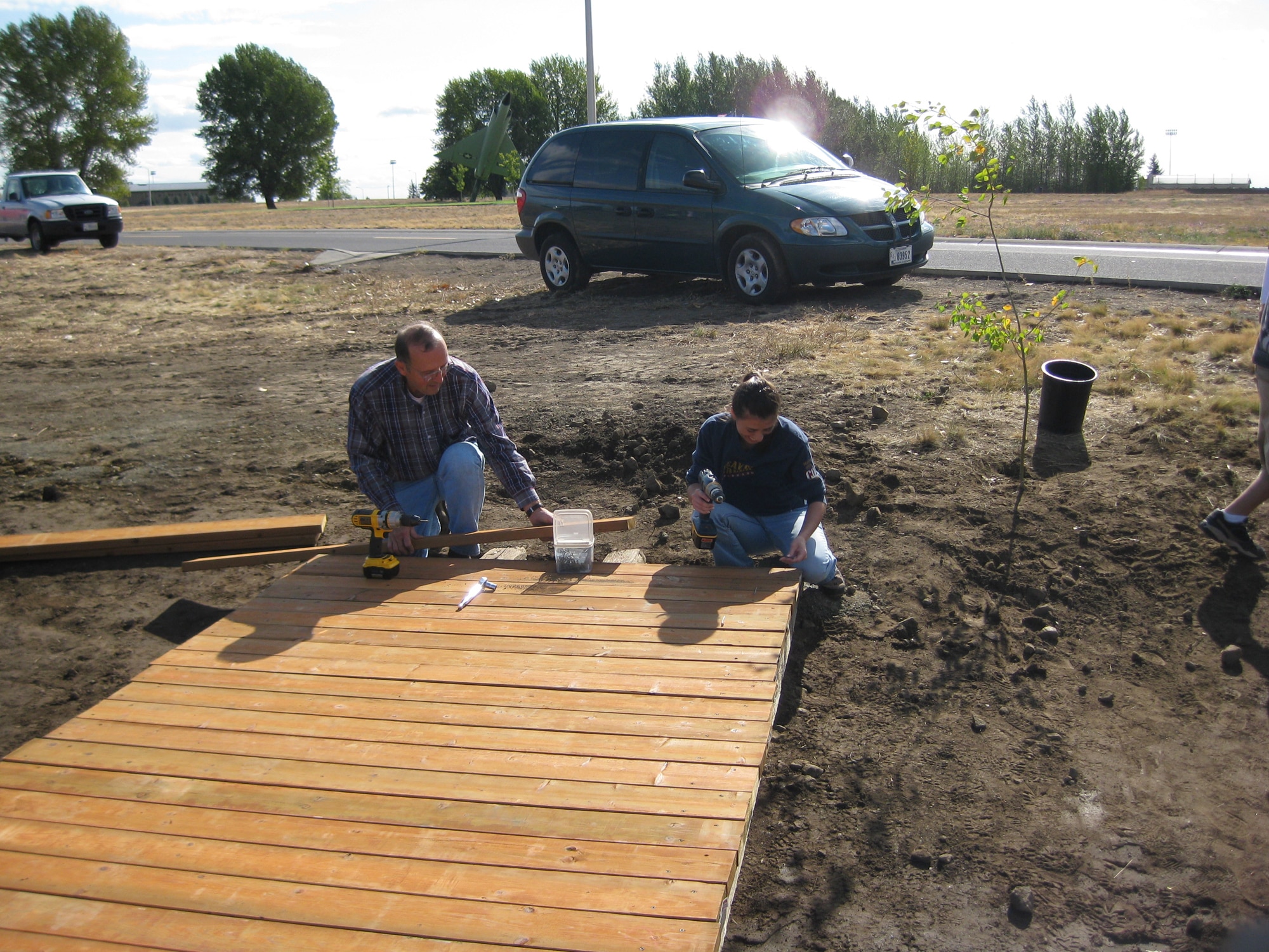 FAIRCHILD AIR FORCE BASE, Wash. – Ron Horlacher and Sarah Nemer, both from the 92nd Civil Engineer Squadron, work on completing a pedestrian bridge as part of National Public Lands Day Sept. 25. (U.S. Air Force photo / Mary Farver)