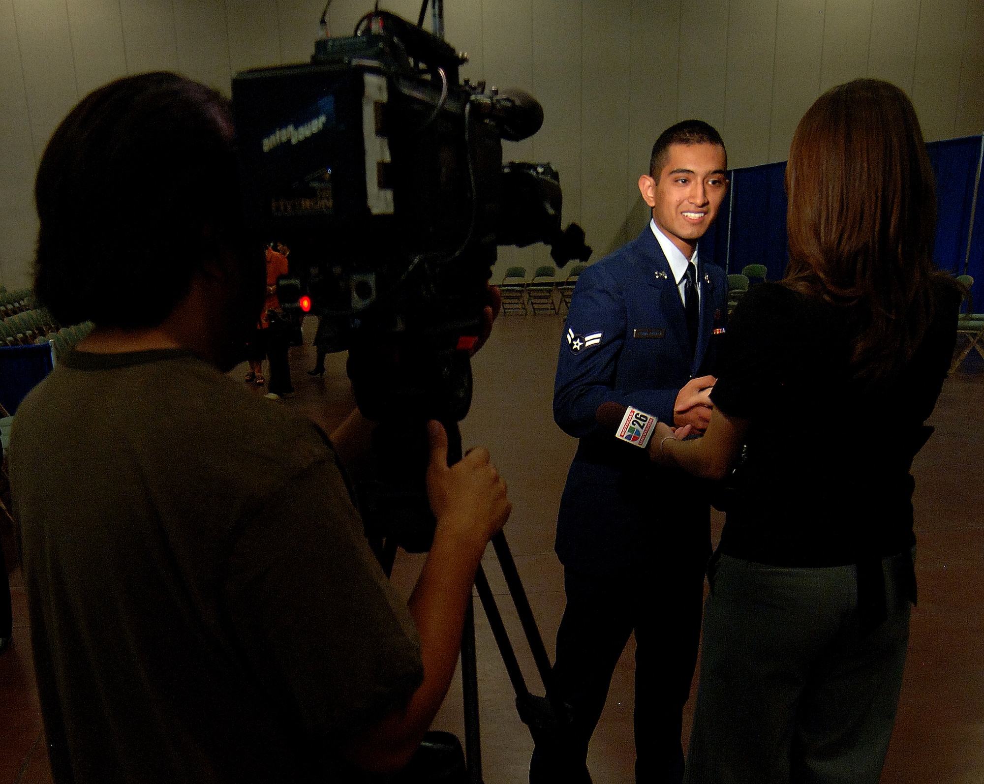 Airman 1st Class Jesse Lerma, 49th Mission Support Group, is interviewed  by Univision's Ms. Heidi Renpenning, after his naturalization ceremony, September 24. More than 1200 applicants were granted U.S. citizenship at the Convention and Performing Arts Center that was transformed into a federal court room in El Paso, Texas.  (U.S. Air Force photo/Airman 1st Class Michael Means)