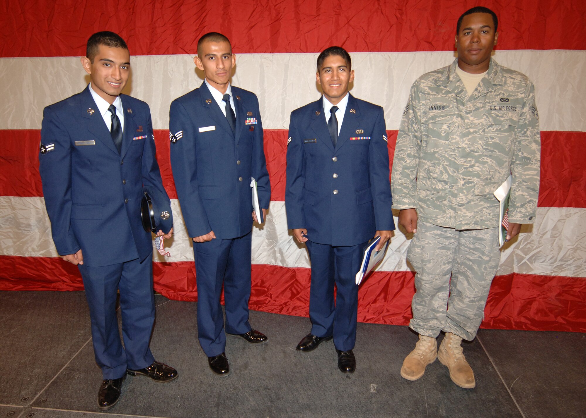 Four Airmen from  Holloman Air Force Base, N.M., pose after their naturalization ceremony, September 24. More than 1,200 applicants were granted U.S. citizenship at the Convention and Performing Arts Center that was transformed into a federal court room in El Paso, Texas.  (U.S. Air Force photo/Airman 1st Class Michael Means)