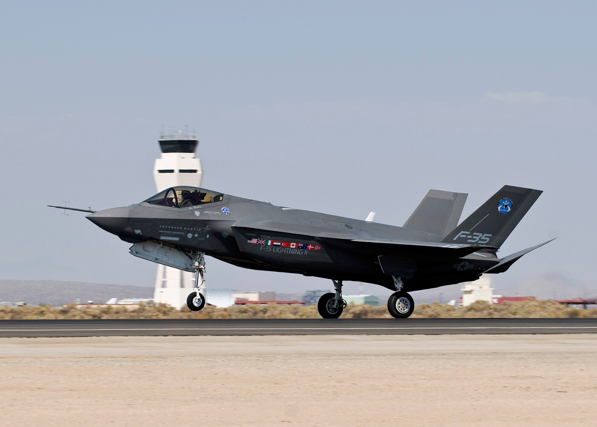 An F-35 Joint Strike Fighter, numbered AA-1, taxis past the control tower on Edwards Air Force Base, Calif., Oct. 1. It marked the first time the aircraft arrived here. The F-35 will perform a series of tests, including airstart and noise testing. The aircraft flew in from Naval Air Station Fort Worth, Texas. The F-35 is a stealthy, single-engine, supersonic multi-role fighter that will replace a variety of aging fighter and strike aircraft for the Air Force, Navy, Marine Corps and allied defense forces. The A-10 Thunderbolt, F-16 Fighting Falcon, F/A-18 Hornet and A/V-8 Harrier are among the jets it will replace. Once fielded, it will complement the fleet of F-22 Raptor air-supremacy fighters that are already operational. (Lockheed Martin photo courtesy/Andy Wolfe) 
