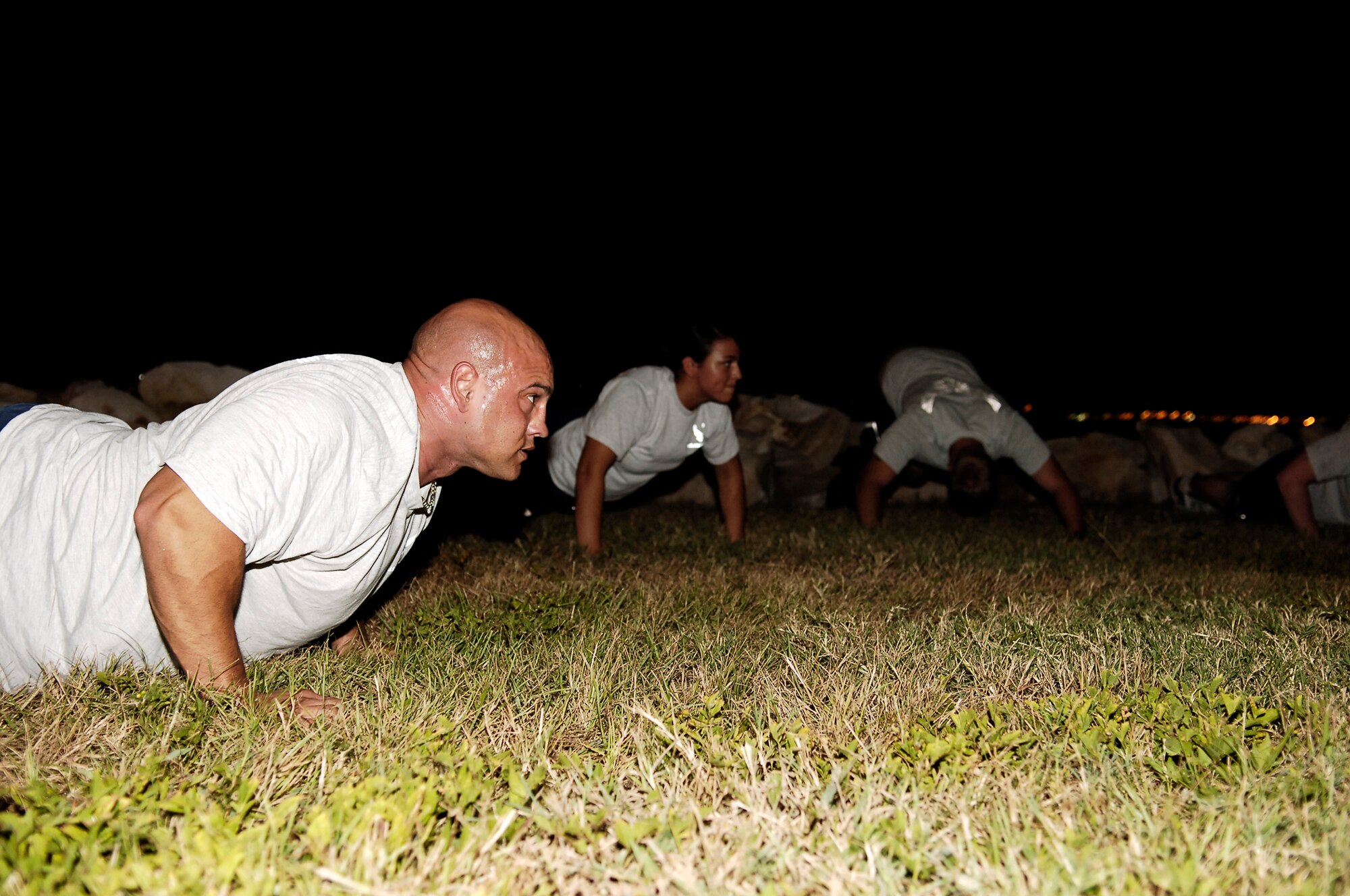 After his shift as 6th Security Forces Squadron Bravo Flight Chief, Tech. Sgt. David Lamyotte participates in an evening Physical Training Session on Bayshore Boulevard MacDill Air Force Base Florida.  The session consisted of stretching, pyramid push-ups and crunches followed by a two mile run along Bay shore Boulevard.  (U.S. Air Force Photo by Tech. Sgt. Sean M. White)