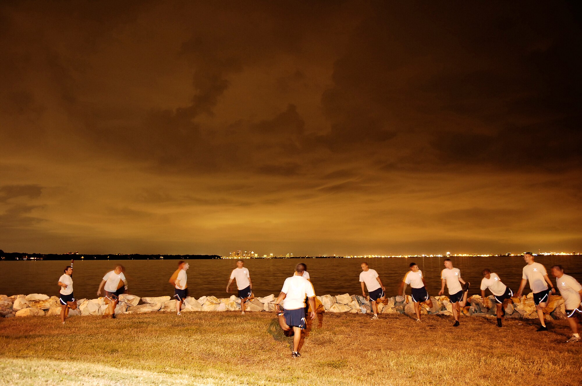 Members of the 6th Security Forces Squadron perform group physical training lead by member of the base marine patrol Senior Airman Alan Evans, at 9:30 p.m.after getting off of shift. The session consisted of stretching, pyramid push-ups and crunches followed by a two mile run along Bayshore Boulevard.  (U.S. Air Force Photo by TSgt Sean M. White)