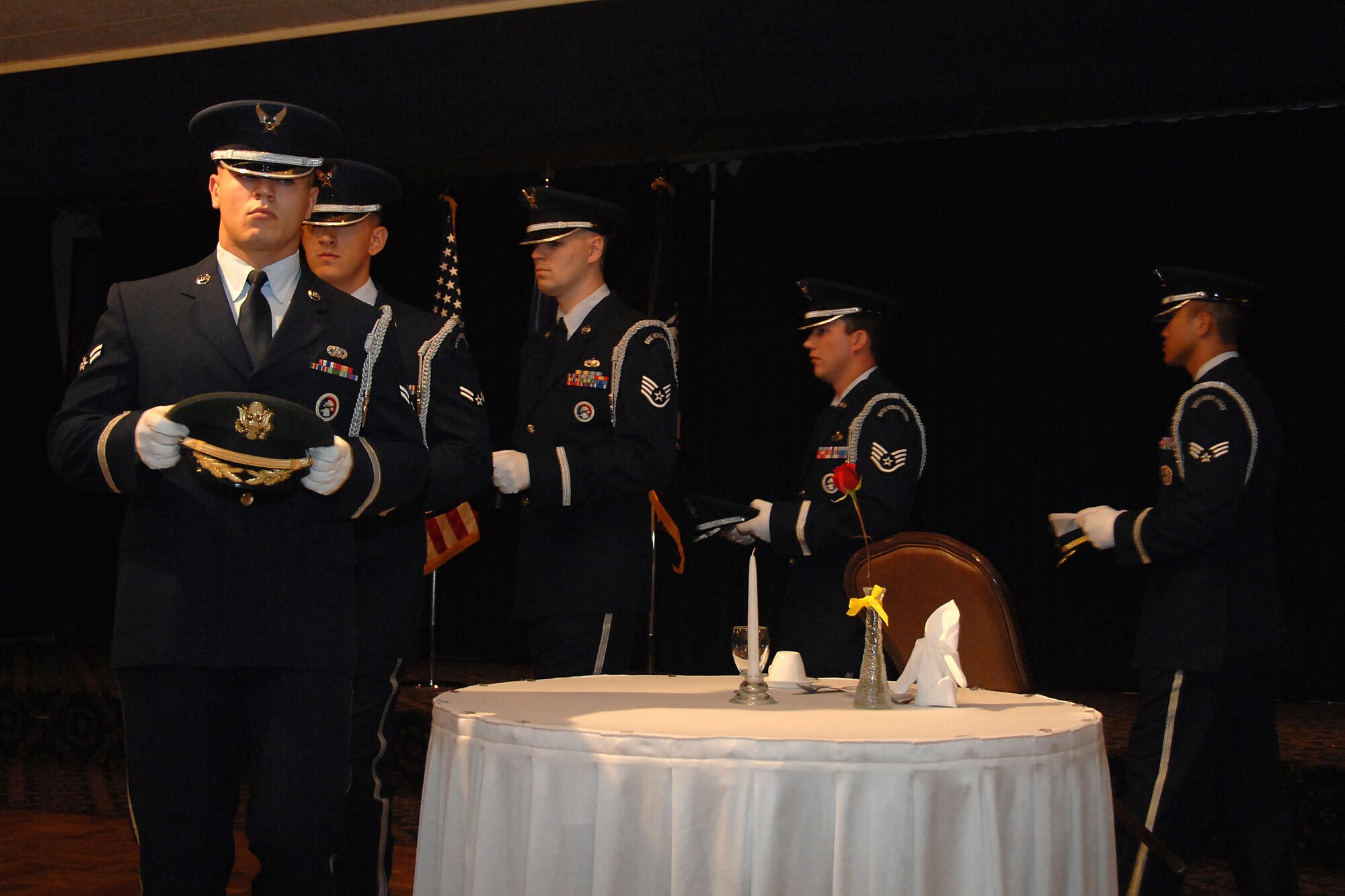 Members of Offutt AFB’s Honor Guard lay hats on a POW/MIA table in honor of those missing in action or held as prisoners of war during the 14th Annual First Sergeants Association's POW/MIA Recognition Ceremony at the Patriot Club here Sept. 29.  (U.S. Air Force Photo By Josh Plueger)