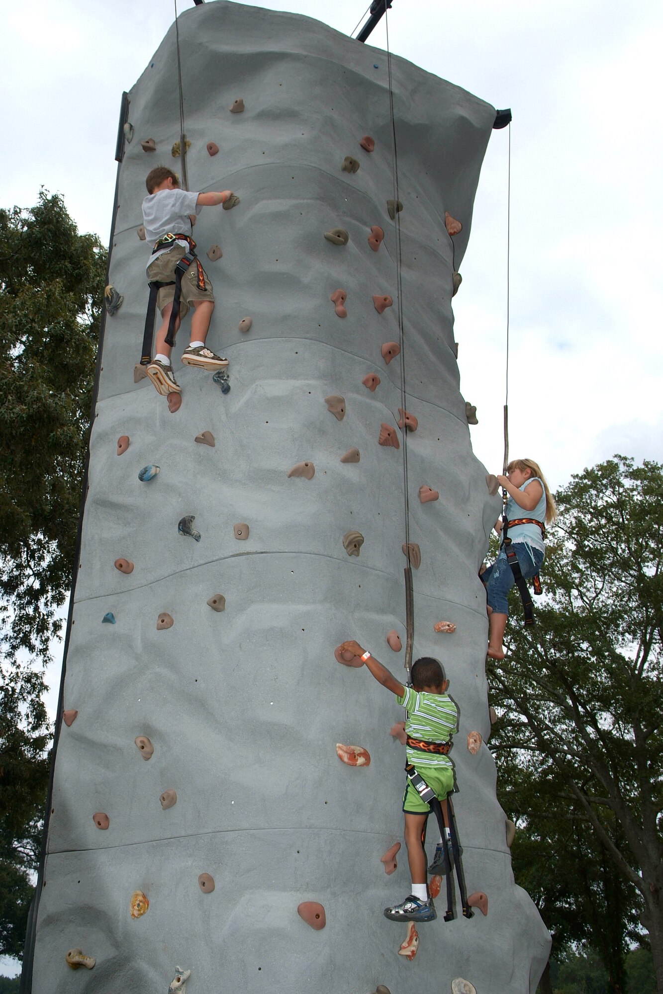 Summer Bash attendees try out the rock wall, one of several attractions at the end-of-summer event. U. S. Air Force photo by Gary Cutrell