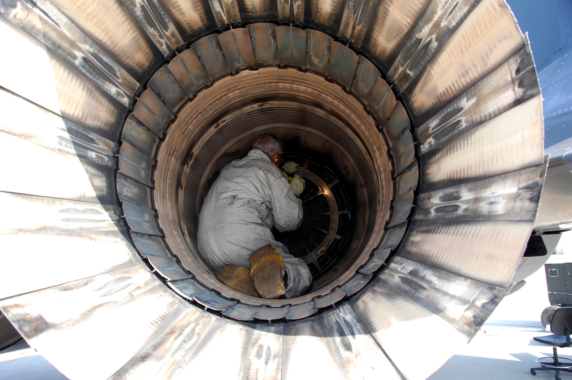 Chuck Studstill with the F-15 Functional Test Unit does pre-flight inspection of the intake and exhaust prior to flight. U. S. Air Force photo by Claude Lazzara