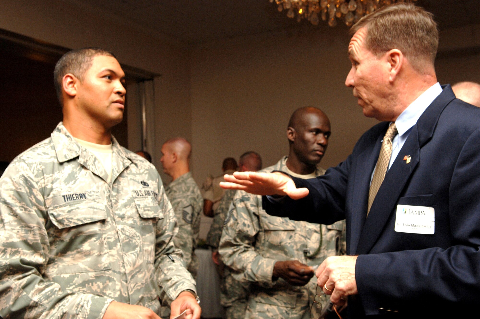 Tom Mackiewicz, USAA Representative, speaks to Master Sgt. Brent Thierry, 6th Communications Squadron, about his organization during the Greater Tampa Chamber of Commerce Senior Enlisted reception Sept. 25, held at the enlisted club. USAA, along with other members of The Chamber, holds this event in support of military members.  (U.S. Air Force Photo by Senior Airman Nancy Hooks) 
