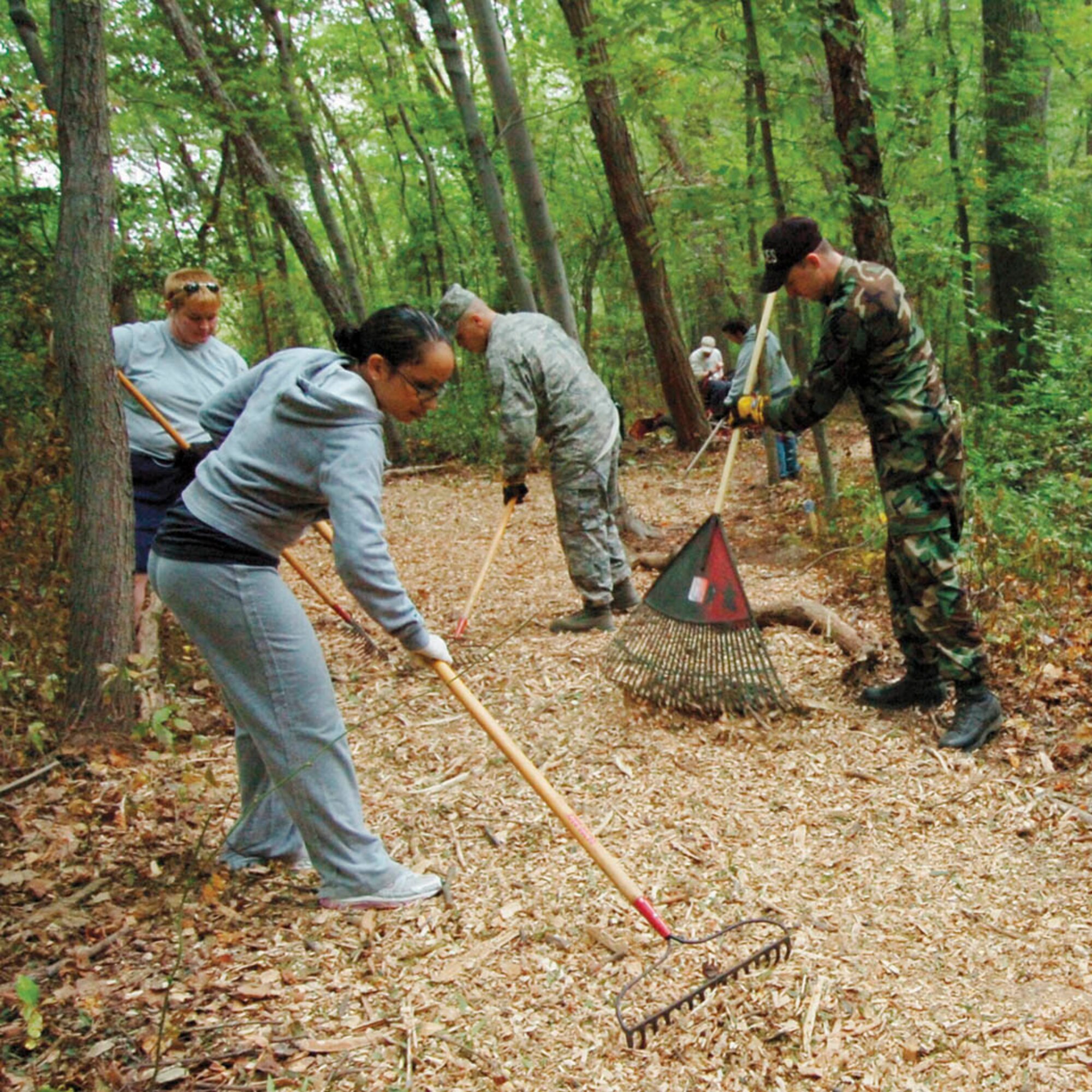 A cadre of of volunteers spread wood chips across the trail during National Public Land Day observance at Yuma Park.  Approximately 53 military and civilian members from various squadrons from Andrews and Bolling Air Force Base participated in the park spruce up Sept. 25.  (USAF photo by Bobby Jones)