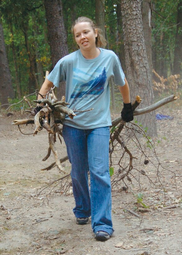 Emily McBride, 316th Civil Engineer  Assett Management Flight prevention pollution manager, hauls a load of dead tree branches to be chopped into wood chips Sept. 25 during the Yuma Park cleanup in honor of National Public Lands Day.  (USAF photo by Bobby Jones)