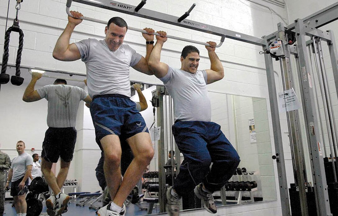 Col. Steven Shepro, 316th Wing Commander (left), and Capt. Josh “Chewy” Cherkinsky (right), 316th Comptroller Squadron, surpass their goal of 40 pull-ups Thursday morning at the West Fitness Center.  Colonel Shepro accepted the captain’s pull-up challenge last month; “Combat fitness works for the wing as it does for each of its members — we set goals and team with others who push us to meet and exceed those goals. The West Fitness Center will open its CrossFit complex within three months to help the wing to reach new fitness goals to support unit combat fitness training.  (USAF photo by Senior Airman Giang Dong Nguyen)