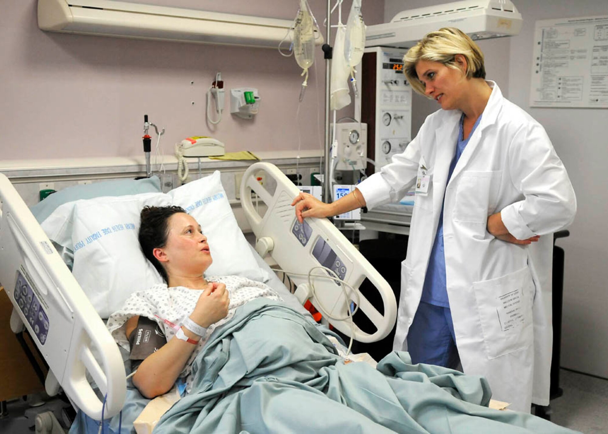 Major Christine Gundel, 779th Medical Group nurse midwife, checks on Monica McCoy, Public Affairs Specialist for Naval Sea Systems Command in Washington D.C. and patient at the Maternal Child Unit at Malcolm Grow Medical Center, before her scheduled cesarean-section.   (USAF photo by Tech. Sgt. Suzanne M. Day)