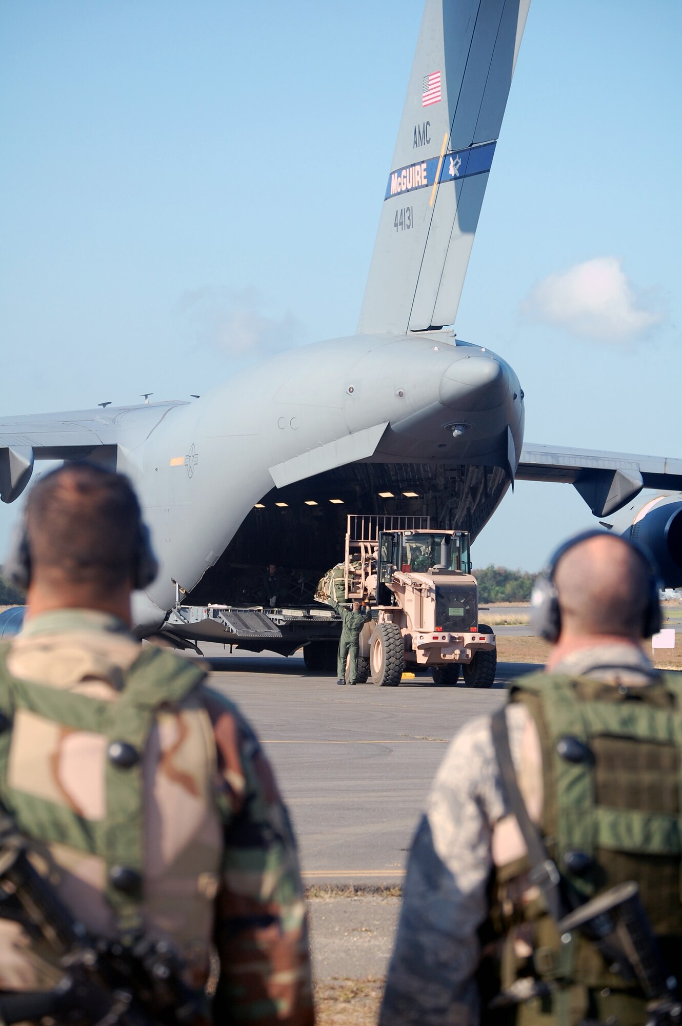 Airmen deployed to Air Force Exercise Eagle Flag 08-6 watch an extreme terrain forklift load a C-17 Globemaster III from McGuire Air Force Base, N.J., during exercise operations at Naval Air Engineering Station Lakehurst, N.J., Sept. 23, 2008.  The exercise, managed by the U.S. Air Force Expeditionary Center's 421st Combat Training Squadron at Fort Dix, N.J., tests and trains Airmen in expeditionary combat support skills.  (U.S. Air Force Photo/Tech. Sgt. Scott T. Sturkol)