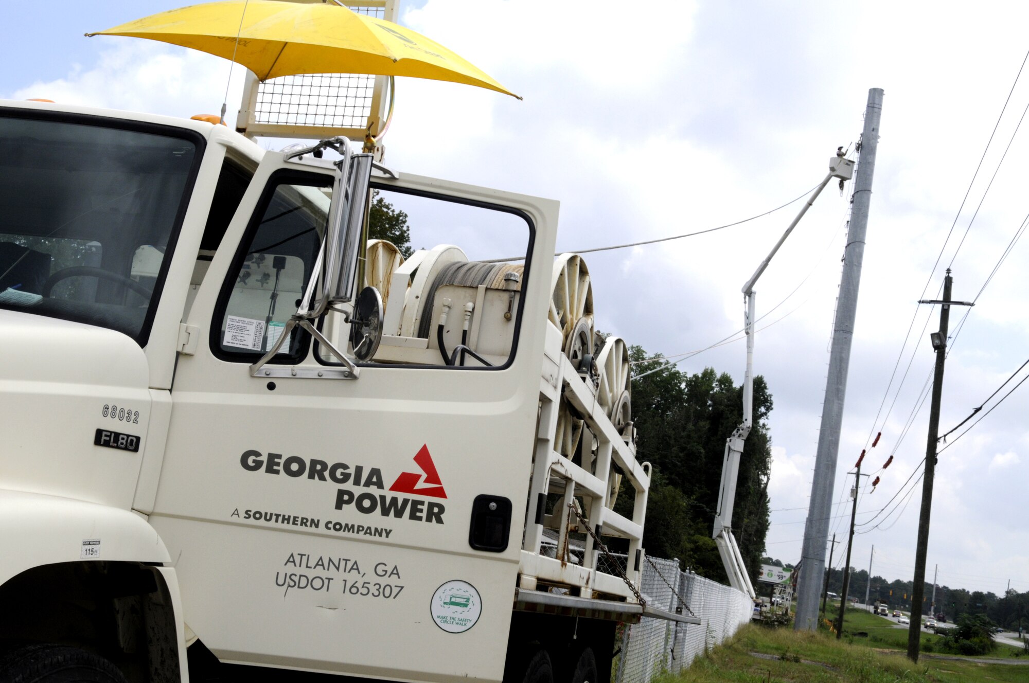 Georgia Power crews install transmission lines along Ga. Hwy 247 in preparation for an electrical substation that will power industrial airfield facilities and associate units. U. S. Air Force photo by Sue Sapp