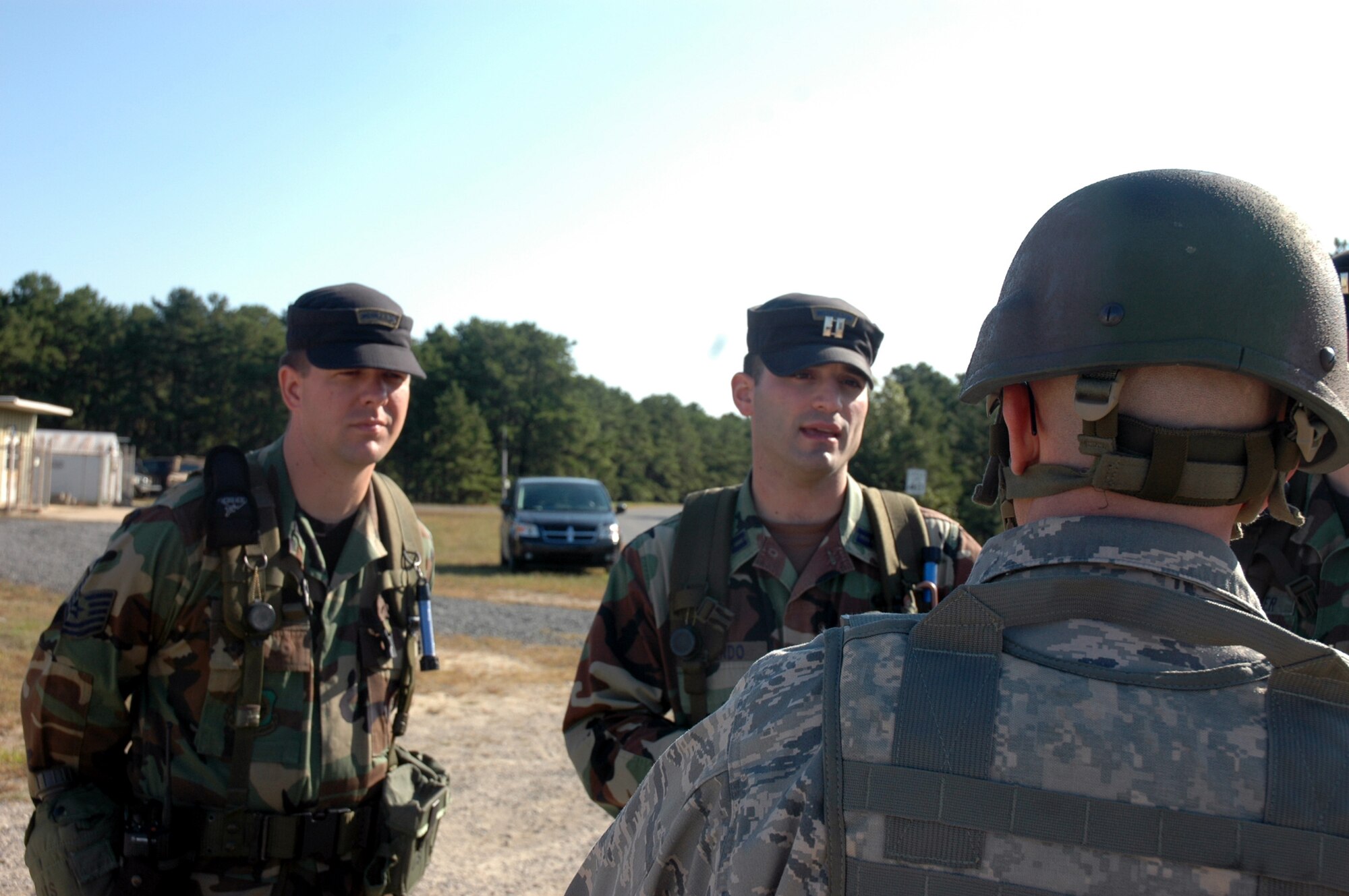 Tech. Sgt. Keith Vershay and Capt. Paulino Caliendo, both from the U.S. Air Force Expeditionary Center's legal office, talk with students during exercise operations at Naval Air Engineering Station Lakehurst, N.J., Sept. 23, 2008.  The exercise, managed by the USAF EC's 421st Combat Training Squadron at Fort Dix, N.J., tests and trains Airmen in expeditionary combat support skills.  (U.S. Air Force Photo/Tech. Sgt. Scott T. Sturkol)