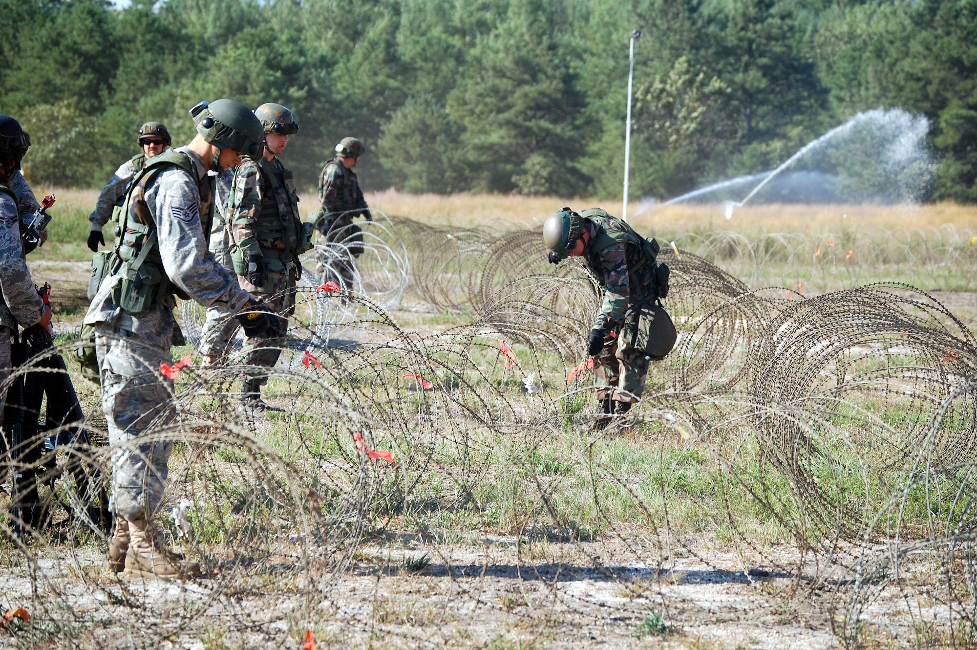 Airmen deployed to Air Force Exercise Eagle Flag 08-6 set up concertina wire around the camp during exercise operations at Naval Air Engineering Station Lakehurst, N.J., Sept. 23, 2008.  The exercise, managed by the U.S. Air Force Expeditionary Center's 421st Combat Training Squadron at Fort Dix, N.J., tests and trains Airmen in expeditionary combat support skills.  (U.S. Air Force Photo/Tech. Sgt. Scott T. Sturkol)