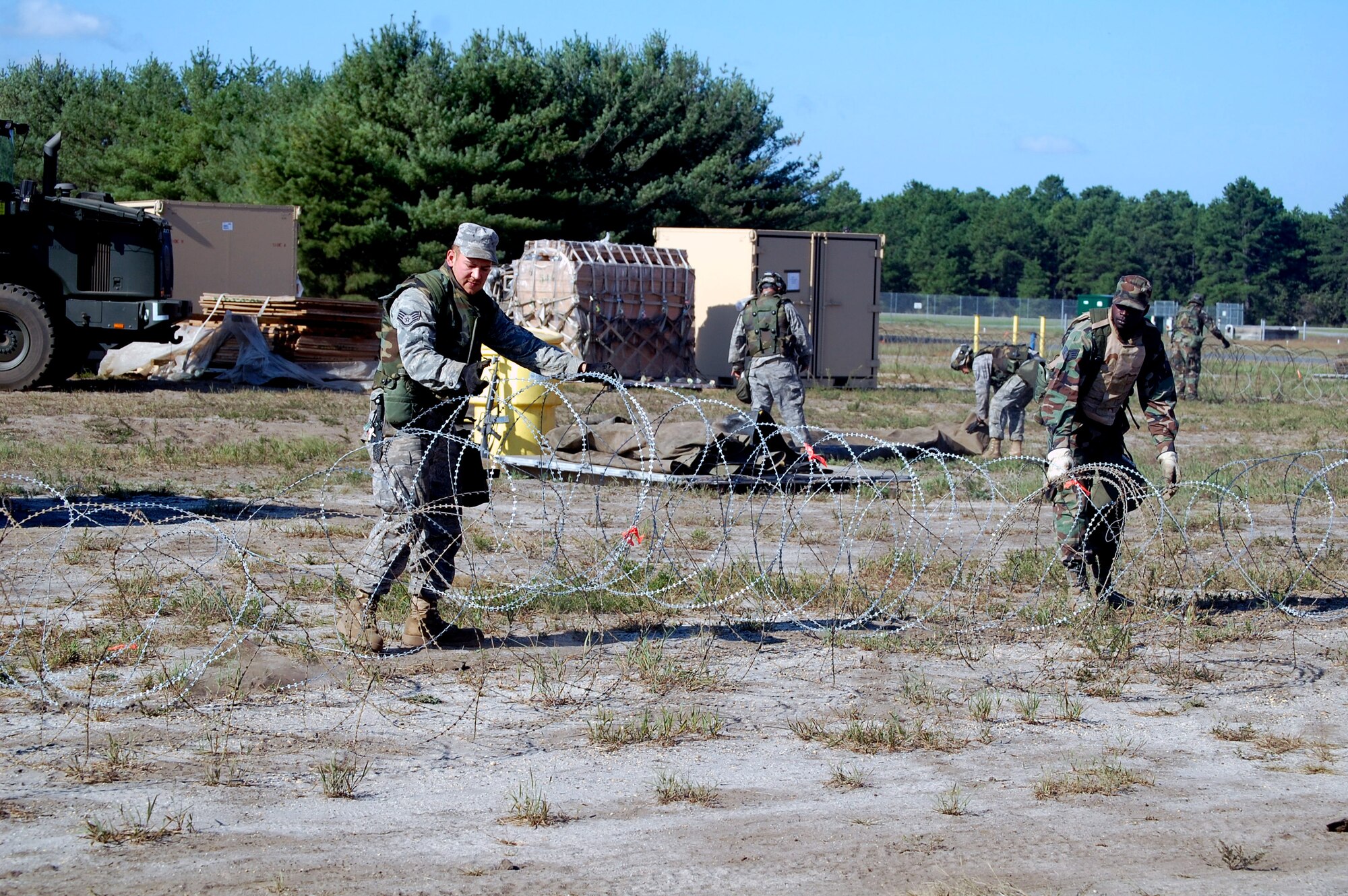 An Airman deployed to Air Force Exercise Eagle Flag 08-6 set up concertina wire around the camp during exercise operations at Naval Air Engineering Station Lakehurst, N.J., Sept. 23, 2008.  The exercise, managed by the U.S. Air Force Expeditionary Center's 421st Combat Training Squadron at Fort Dix, N.J., tests and trains Airmen in expeditionary combat support skills.  (U.S. Air Force Photo/Tech. Sgt. Scott T. Sturkol)
