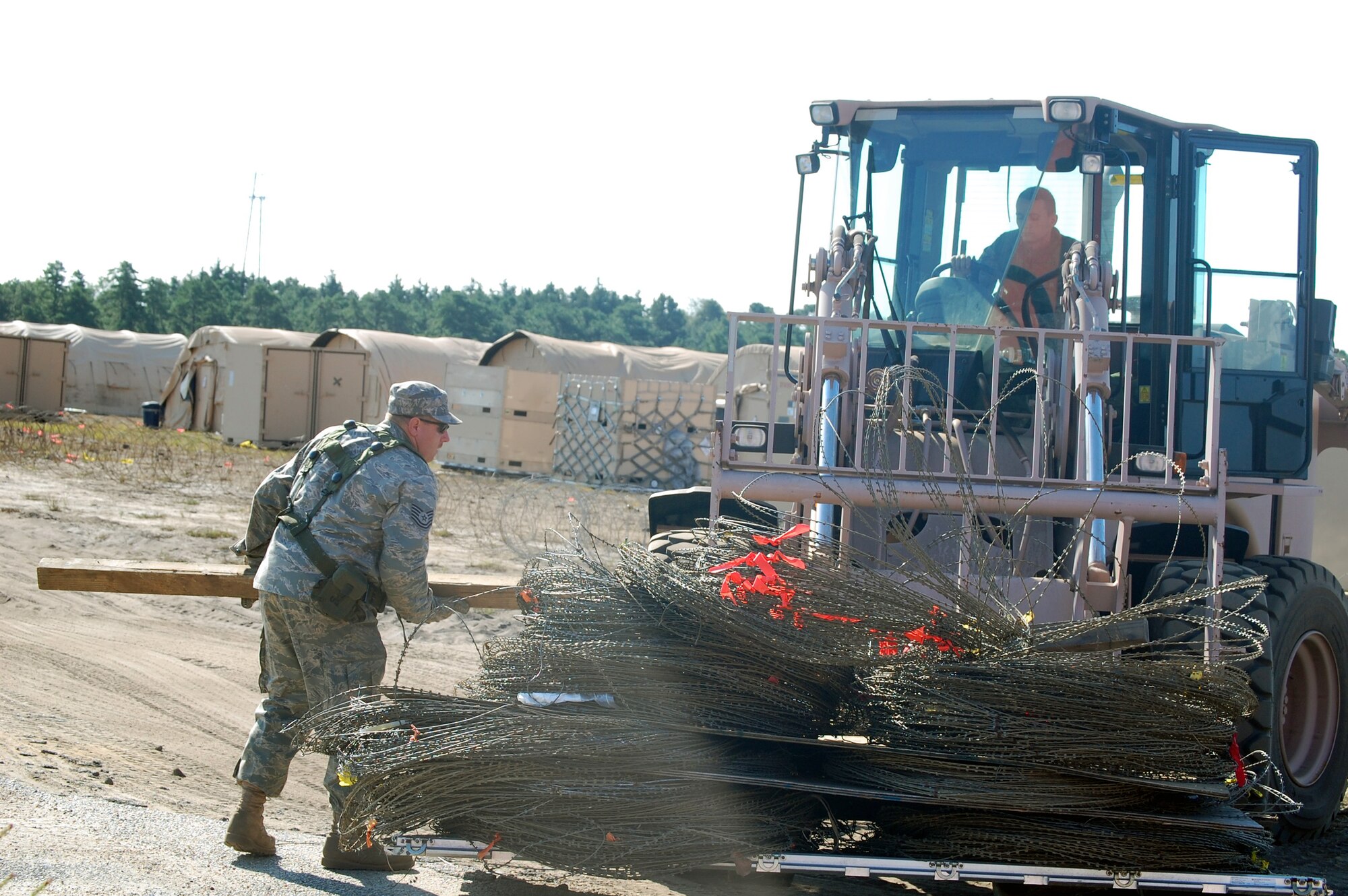 Airmen deployed to Air Force Exercise Eagle Flag 08-6 use an extreme terrain forklift to move concertina wire around the camp during exercise operations at Naval Air Engineering Station Lakehurst, N.J., Sept. 23, 2008.  The exercise, managed by the U.S. Air Force Expeditionary Center's 421st Combat Training Squadron at Fort Dix, N.J., tests and trains Airmen in expeditionary combat support skills.  (U.S. Air Force Photo/Tech. Sgt. Scott T. Sturkol)