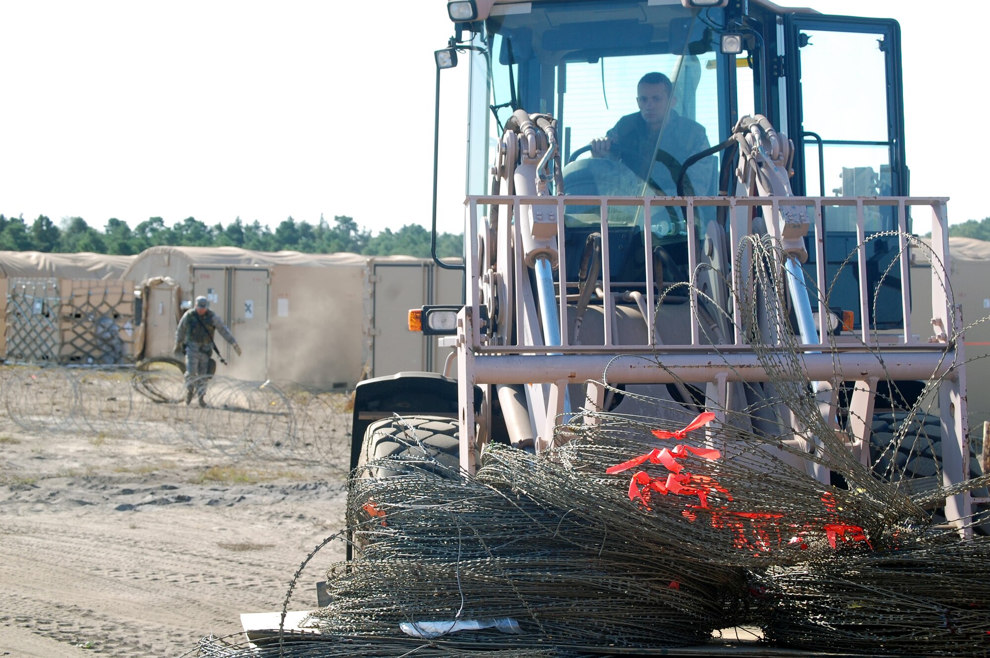 An Airman deployed to Air Force Exercise Eagle Flag 08-6 uses an extreme terrain forklift to move concertina wire around the camp during exercise operations at Naval Air Engineering Station Lakehurst, N.J., Sept. 23, 2008.  The exercise, managed by the U.S. Air Force Expeditionary Center's 421st Combat Training Squadron at Fort Dix, N.J., tests and trains Airmen in expeditionary combat support skills.  (U.S. Air Force Photo/Tech. Sgt. Scott T. Sturkol)