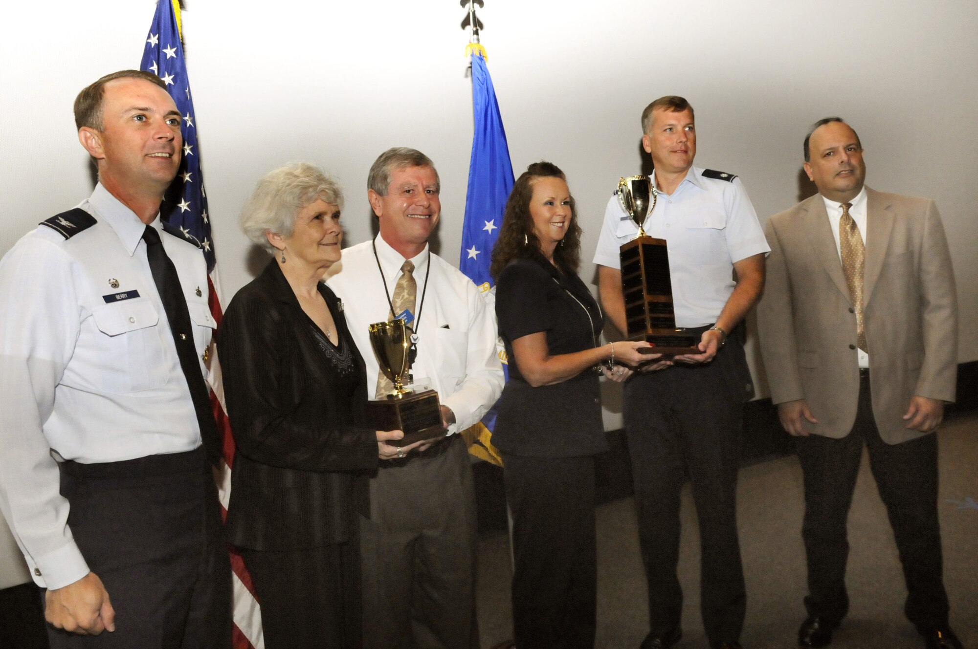 The 580th Aircraft Sustainment Group was the winner of this year's Community Service Award. Pictured are Col. Warren Berry, 78th Air Base Wing Commander, Kathy Smith, 580th ACSG workflow contractor support, John Adams, 580th Aircraft Sustainment Group director, Denise Smith, 580th ACSG workflow chief Lt. Col. William Hanig, 580th deputy director, and Ed Rodriguez, Warner Robins Chamber of Commerce president. U. S. Air Force photo by Sue Sapp