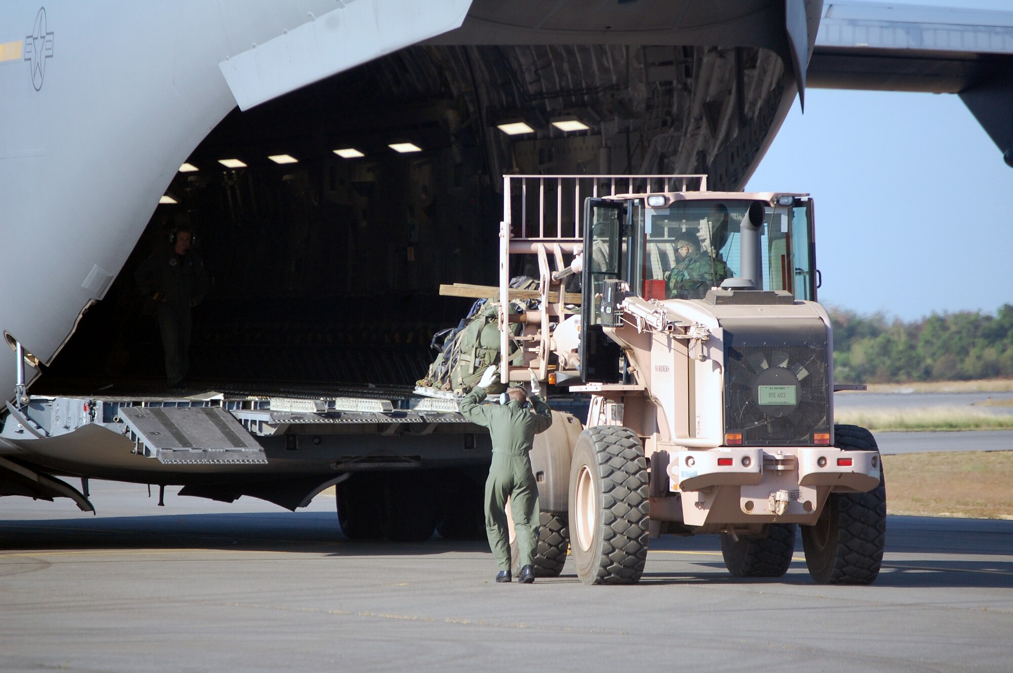 An extreme terrain forklift carries a pallet to the back of a C-17 Globemaster III while it is being loaded during operations for Air Force Exercise Eagle Flag 08-6 Sept. 23, 2008, at Naval Air Engineering Station Lakehurst, N.J.  The C-17, from McGuire Air Force Base, N.J., was loading up equipment from the 816th Contingency Response Group, also from McGuire.  Eagle Flag is operated by the U.S. Air Force Expeditionary Center's 421st Combat Training Squadron at Fort Dix, N.J.  (U.S. Air Force Photo/Tech. Sgt. Scott T. Sturkol)
