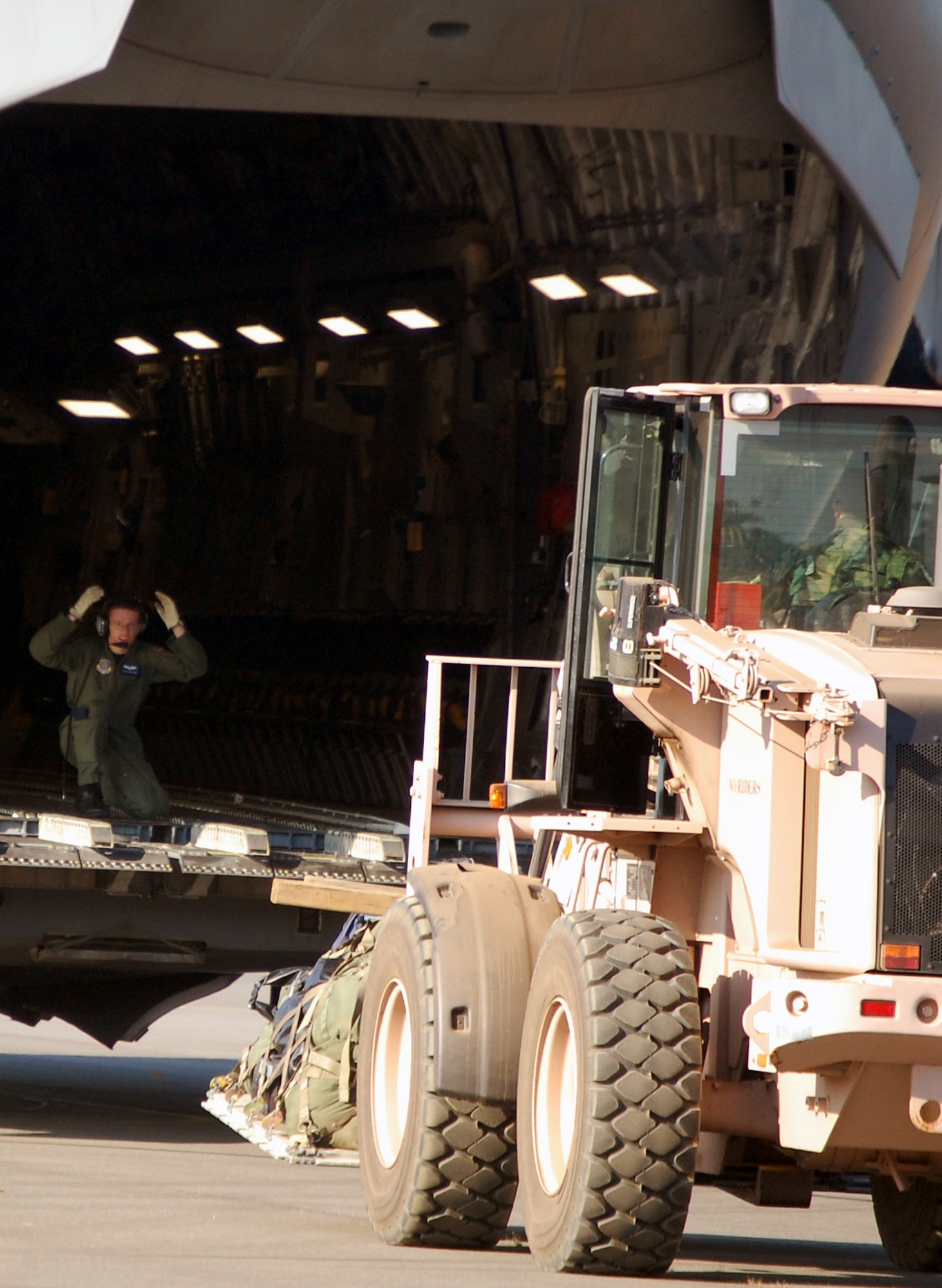 An extreme terrain forklift carries a pallet to the back of a C-17 Globemaster III while it is being loaded during operations for Air Force Exercise Eagle Flag 08-6 Sept. 23, 2008, at Naval Air Engineering Station Lakehurst, N.J.  The C-17, from McGuire Air Force Base, N.J., was loading up equipment from the 816th Contingency Response Group, also from McGuire.  Eagle Flag is operated by the U.S. Air Force Expeditionary Center's 421st Combat Training Squadron at Fort Dix, N.J.  (U.S. Air Force Photo/Tech. Sgt. Scott T. Sturkol)
