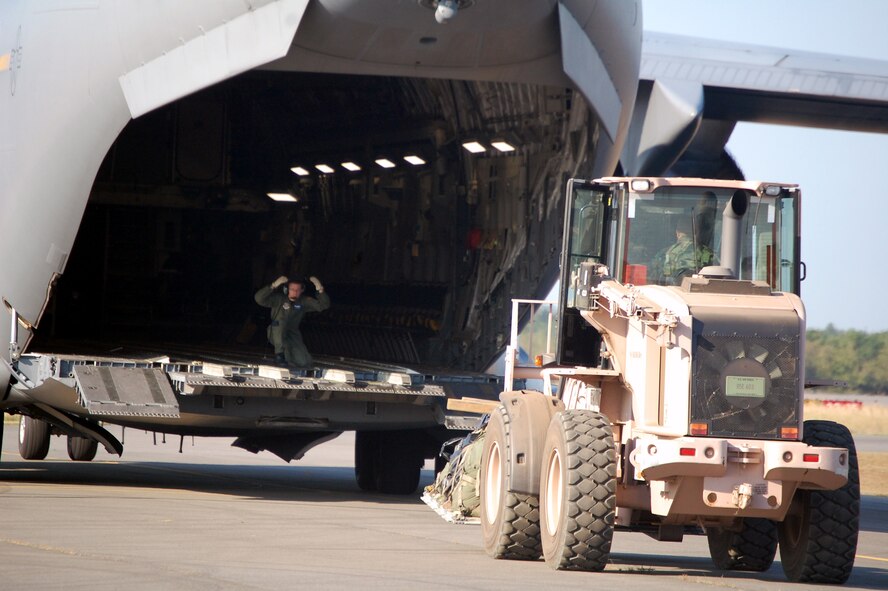 An extreme terrain forklift carries a pallet to the back of a C-17 Globemaster III while it is being loaded during operations for Air Force Exercise Eagle Flag 08-6 Sept. 23, 2008, at Naval Air Engineering Station Lakehurst, N.J.  The C-17, from McGuire Air Force Base, N.J., was loading up equipment from the 816th Contingency Response Group, also from McGuire.  Eagle Flag is operated by the U.S. Air Force Expeditionary Center's 421st Combat Training Squadron at Fort Dix, N.J.  (U.S. Air Force Photo/Tech. Sgt. Scott T. Sturkol)