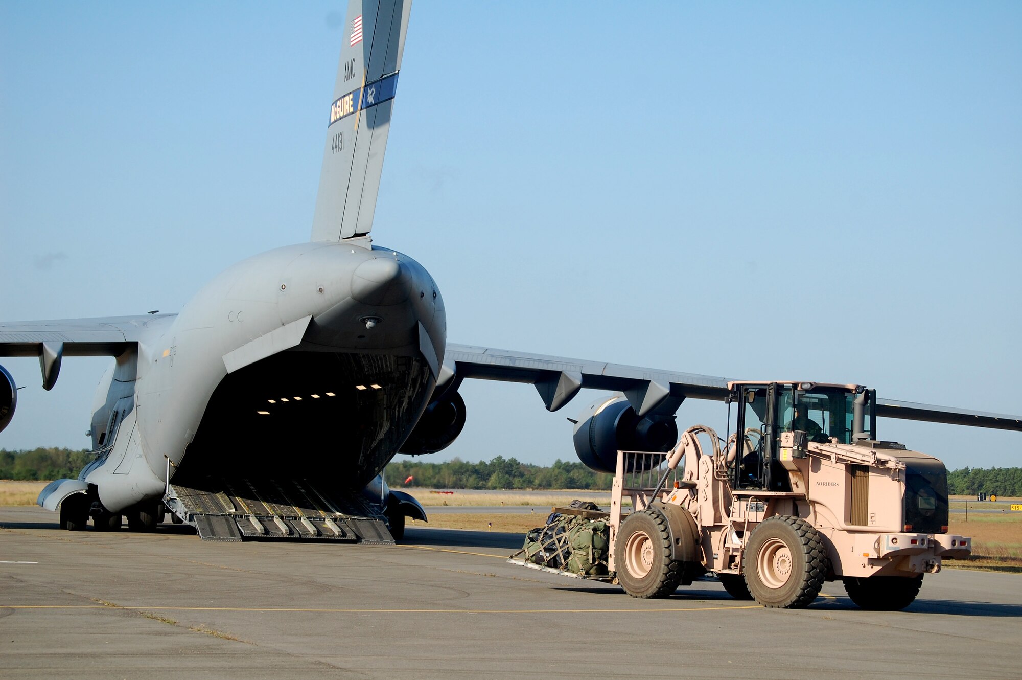An extreme terrain forklift carries a pallet to the back of a C-17 Globemaster III while it is being loaded during operations for Air Force Exercise Eagle Flag 08-6 Sept. 23, 2008, at Naval Air Engineering Station Lakehurst, N.J.  The C-17, from McGuire Air Force Base, N.J., was loading up equipment from the 816th Contingency Response Group, also from McGuire.  Eagle Flag is operated by the U.S. Air Force Expeditionary Center's 421st Combat Training Squadron at Fort Dix, N.J.  (U.S. Air Force Photo/Tech. Sgt. Scott T. Sturkol)