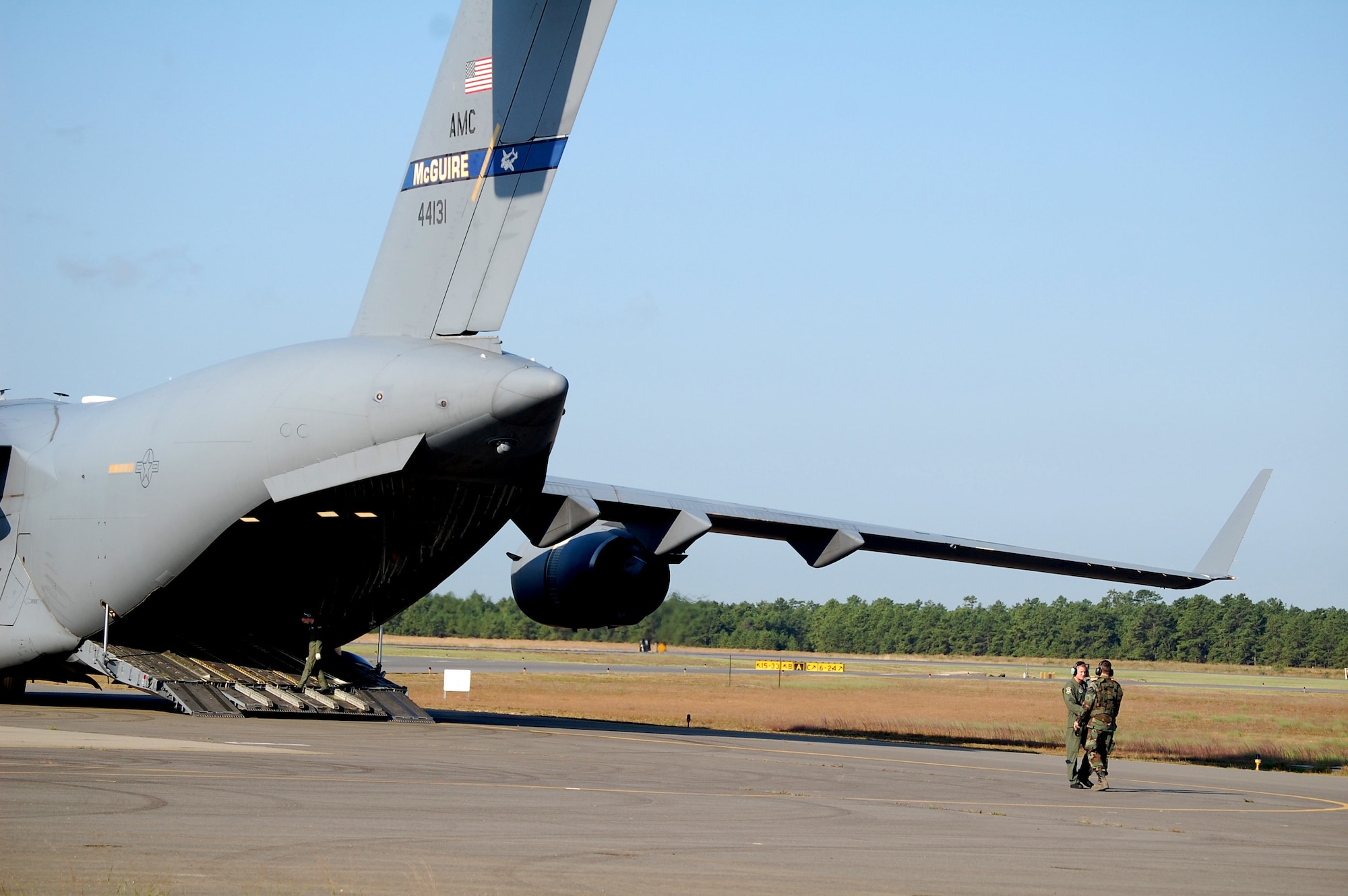 Aircrew members wait by their C-17 Globemaster III in preparation for it to be loaded during operations for Air Force Exercise Eagle Flag 08-6 Sept. 23, 2008, at Naval Air Engineering Station Lakehurst, N.J.  The C-17, from McGuire Air Force Base, N.J., was loading up equipment from the 816th Contingency Response Group, also from McGuire.  Eagle Flag is operated by the U.S. Air Force Expeditionary Center's 421st Combat Training Squadron at Fort Dix, N.J.  (U.S. Air Force Photo/Tech. Sgt. Scott T. Sturkol)