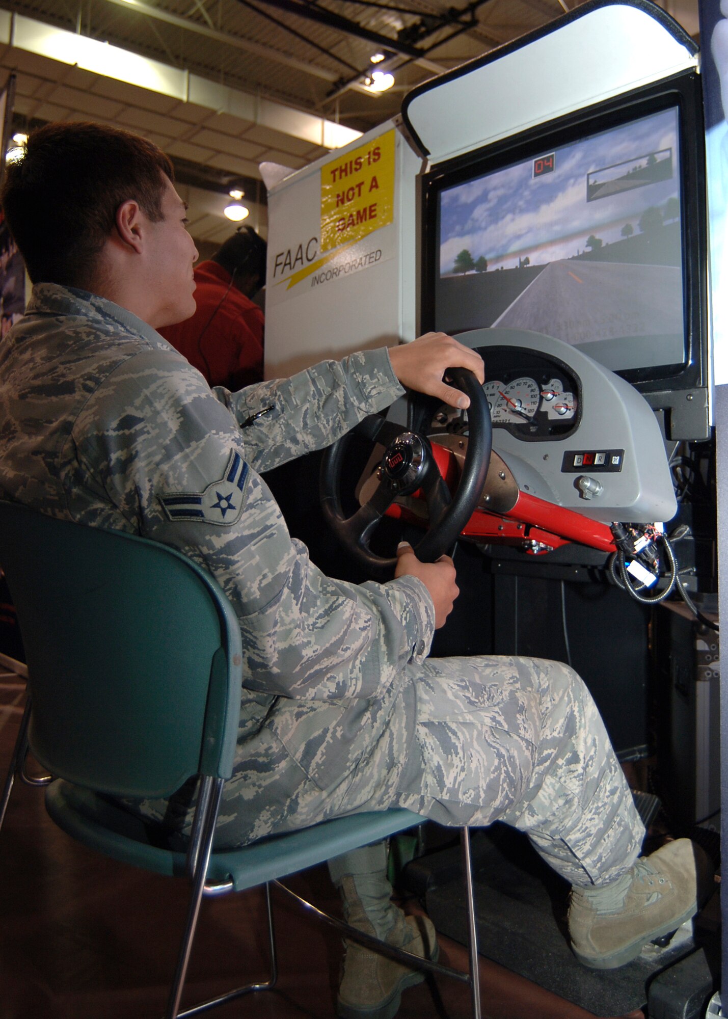 MCCONNELL AIR FORCE BASE, Kan. -- Airman 1st Class Christopher Calderon, 22nd Aircraft Maintenance Squadron, drives a car simulator that help eyes adjust to the drunken driving simulator, Sept. 30. Many of the Airmen that attended the “Save a Life” tour got a chance to drive the drunk driving simulator, watch videos of real life stories of people that were affected by drunk driving, and listen to the tour manager speak about the importance of our actions on the road. (Photo by Airman 1st Class Maria Ruiz)
