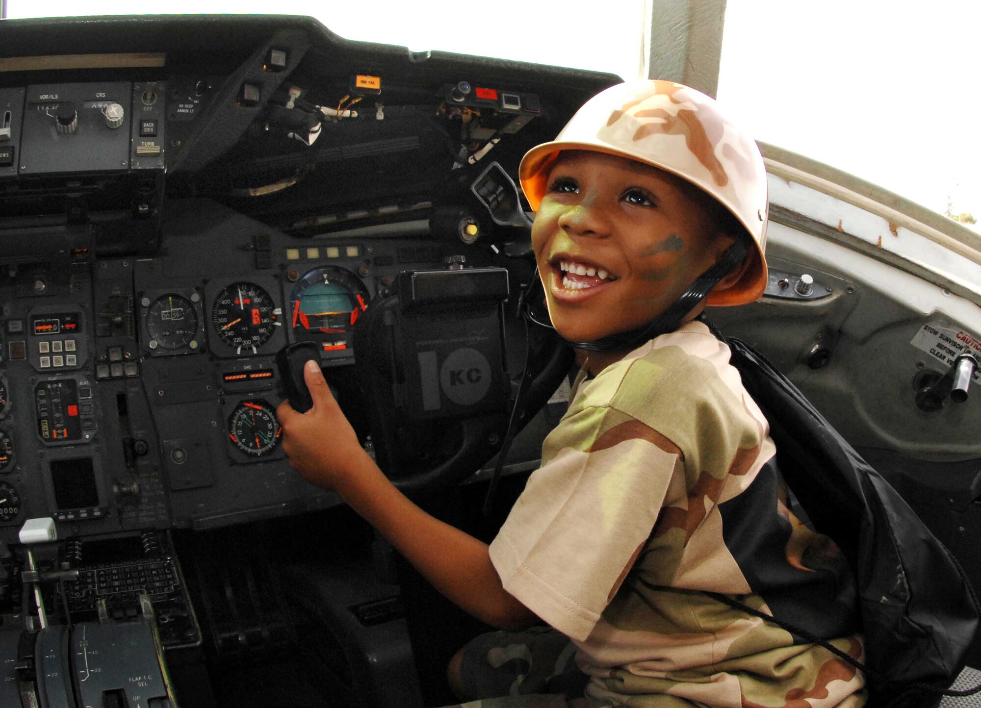 Jahmil Singleton, 6, gets to explore and learn about the KC-10 Extender flight deck, during the Kids Understanding Deployment Operations event Oct. 1.  Better known as KUDOS, the event was designed to give family members a realistic observational understanding of what servicemembers go through before, during and after deployments. (USAF photo/Amanda Lopez)