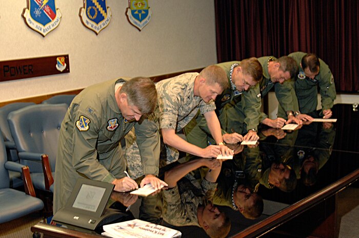 From left to right,  Col. Mark Koechle, 98th Range Wing commander, Col. Dave Belote, 99th Air Base Wing commander, Brig. Gen. Stephen Hoog, U. S. Air Force Warfare Center commander, Brig. Gen Russell Handy, 57th Wing commander, and Col. Steven Depalmer, 53rd Wing commander,  sign their Combined Federal Campaign form Oct. 2, 2008.  The CFC is the only authorized solicitation of Federal employees in their workplaces on behalf of approved charitable organizations and runs at Nellis Oct. 1 to Oct. 31.   (U.S. Air Force Photo/Airman 1st Class Stephanie Rubi)