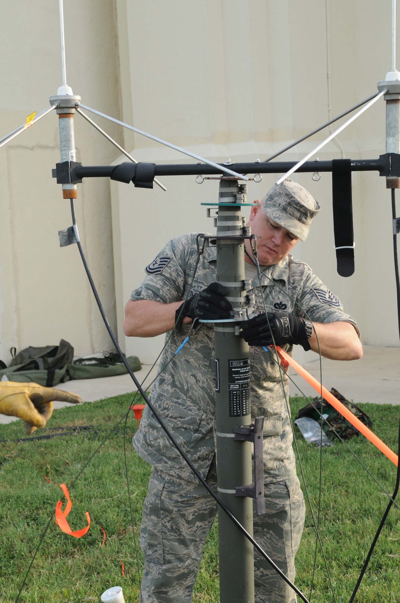 Tech. Sgt. Russell Thetford from the 32nd Combat Communications Squadron, assists in the setup of a VHF radio antenna in support of Hurricane Ike operations at Randolph AFB, Texas.   (Air Force photo)