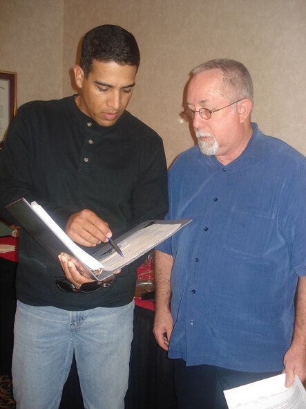 Tech. Sgt.  Alexander Malave, 91st Missile Security Forces Squadron flight chief, and J.R. Williamson, accredited financial counselor and Airmen and Family Readiness Center community readiness consultant, review options for financial education growth.                               