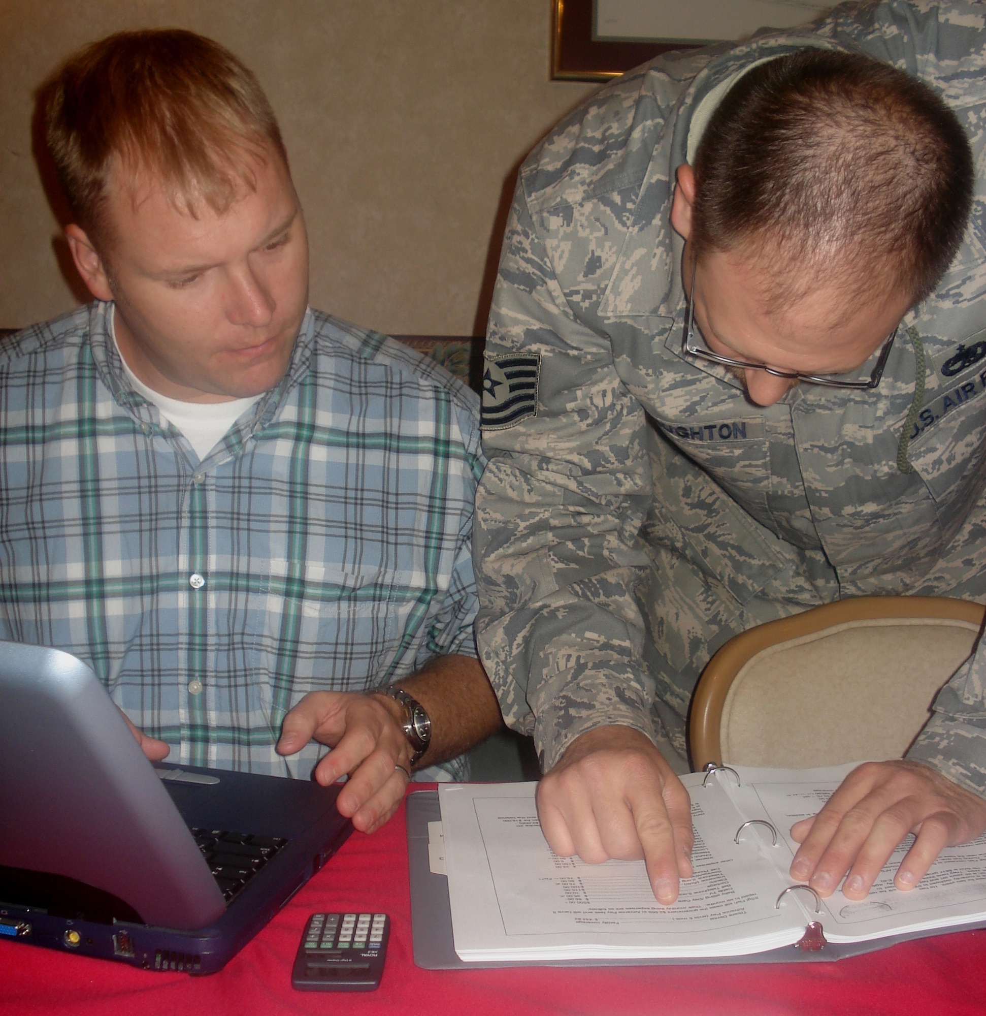 Tech. Sgt. Michael Robinson, 5th Munitions Squadron maintenance floor chief, and Tech. Sgt. Philip Stoughton, 5th Aircraft Maintenance Squadron weapons load team chief,  prepare for a practice financial counseling session. This is the final stage in the four-day training process, and tests their skills and knowledge gained.                                 