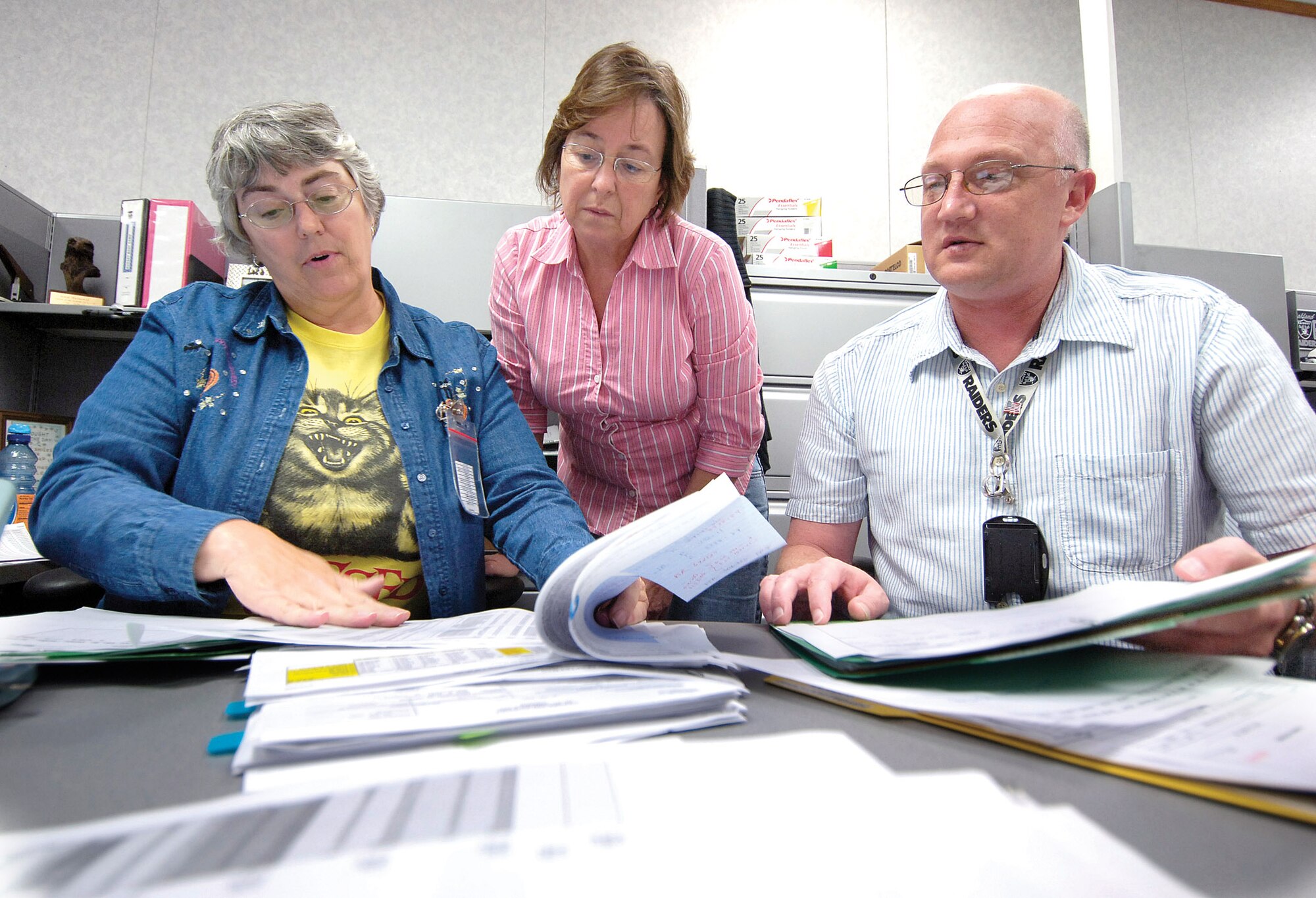 Stacks of papers grow, phones ring and fingers fly over keyboards as the fiscal year end money issues are wrangled by staffs of the 72nd Comptroller Squadron and the 72nd Contracting Squadron.  Expecting a long night, 72nd Comptroller Squadron members Joyce Hathaway, Jean Womble and Robert Rich work the figures.(Air Force photo/Margo Wright)