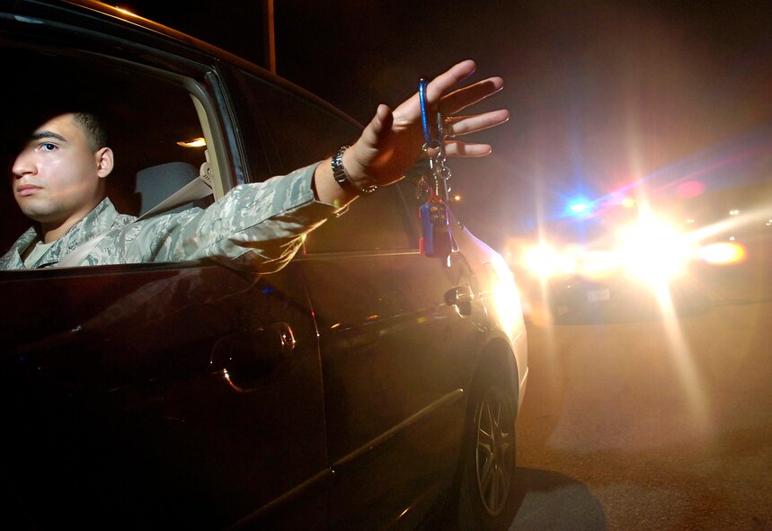 Aside from waiting to respond to any emergencies that may pop-up during the night, Security Forces patrol the base for intruders, traffic violations or impaired drivers. This photo is an illustration only, the Airman shown was not in any kind of trouble. (Air Force photo/Dave Faytinger)