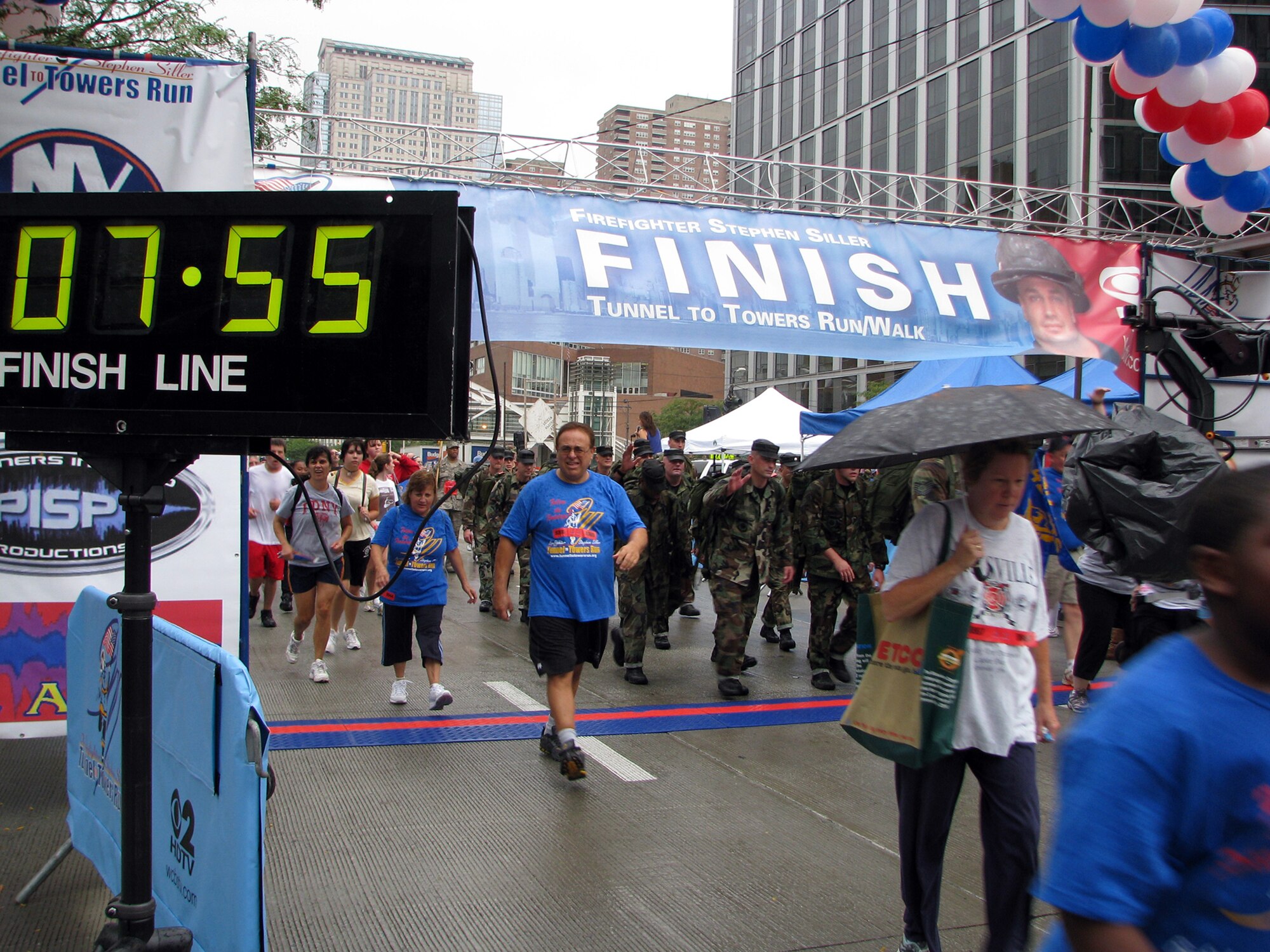 Twenty-one Airmen from the U.S. Air Force Expeditionary Center's 421st Combat Training Sqaudron proudly cross the Tunnel to Towers 5-kilometer Run/Walk finish line in formation with 55 pounds on their backs in New York City Sept. 28, 2008, in one hour, seven minutes time. The Tunnel to Towers is a fundraiser in tribute to Stephen Siller, a New York City firefighter who gave his life on Sept. 11, 2001. Siller ran from his vehicle in full firefighter gear from the Brooklyn Battery Tunnel to the World Trade Center when he heard of the disaster over his scanner. Siller had just come off duty and was headed for a round of golf. (U.S. Air Force photo/Staff Sgt. Paul R. Evans)