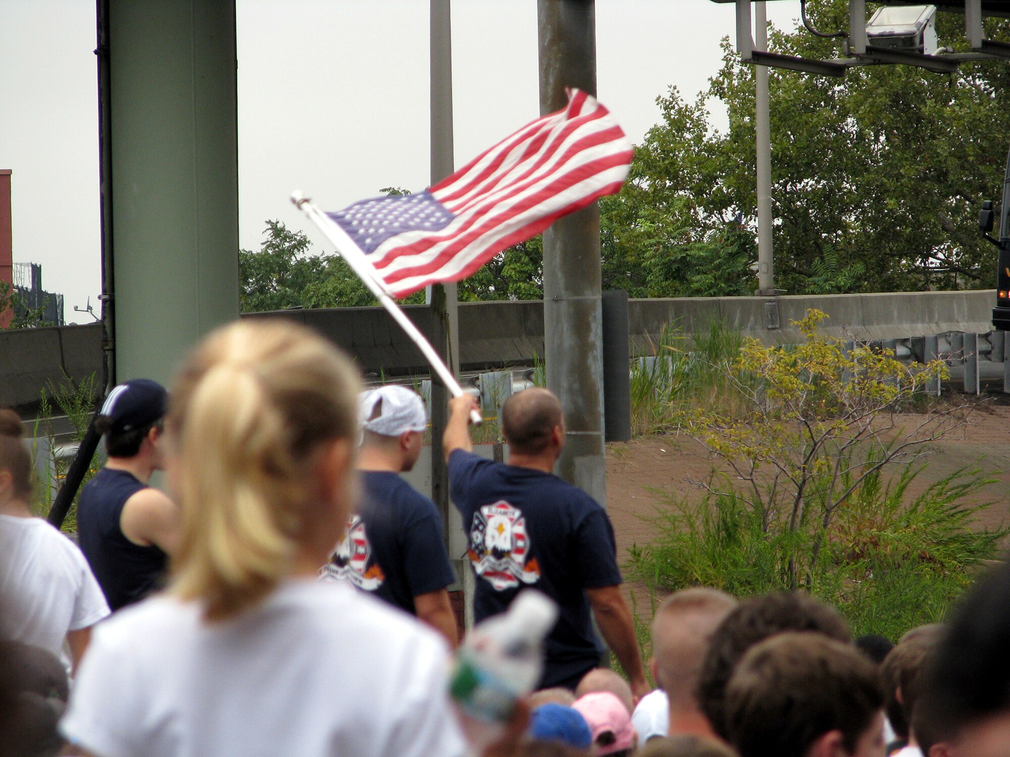 A firefighter waves his American flag with pride during the singing of "God Bless America" during the opening festivities of the Tunnel to Towers 5-kilometer Run/Walk in New York City Sept 28, 2008. The Tunnel to Towers is a fundraiser in tribute to Stephen Siller, a New York City firefighter who gave his life on Sept. 11, 2001.  Siller ran from his vehicle in full firefighter gear from the Brooklyn Battery Tunnel to the World Trade Center when he heard of the disaster over his scanner. Siller had just come off duty and was headed for a round of golf. (U.S. Air Force Photo/Staff Sgt. Paul R. Evans)