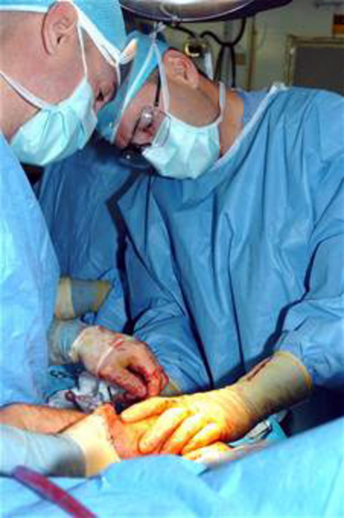 Col. (Dr.) Elisha Powell and Col. (Dr.) Jack Ingari operate on a Soldier wounded in an improvised explosive device attack Dec. 12, 2005, at Joint Base Balad, Iraq. Both served as orthopedic surgeons in 2005 with the 332nd Expeditionary Medical Group at the Air Force Theater Hospital. (U.S. Army photo/Sgt. Dallas Walker)
