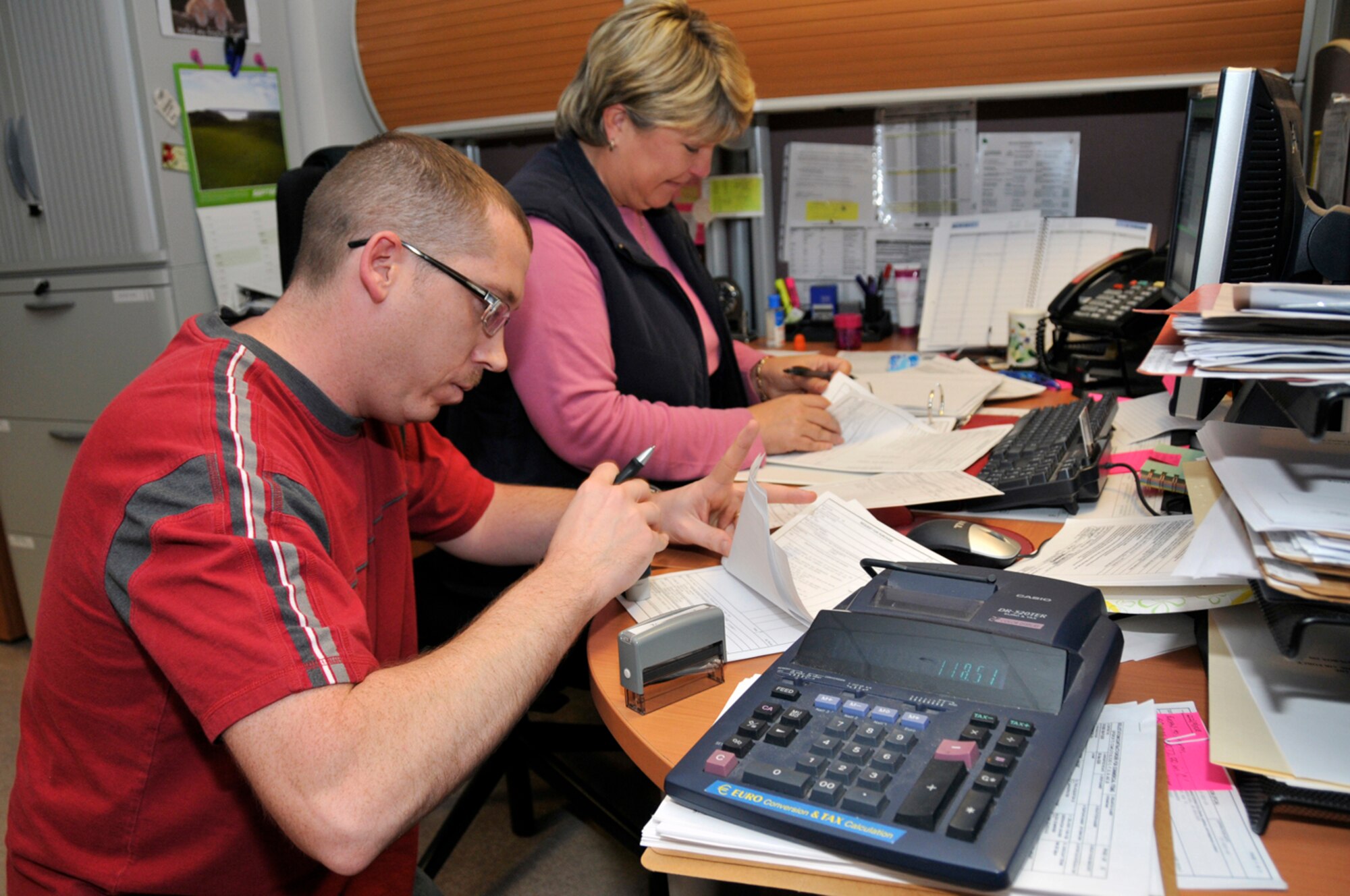 Master Sergeant Ben Dalton, 48th Comptroller Squadron budget analysis for the 48th Medical Group and 48th Fighter Wing staff agencies, and Sue Smyth, 48th Comptroller Squadron budget analysis for the 48th Mission Support Group, certify documents Sept. 30 at RAF Lakenheath, England. Their job is to ensure funding for the contracts starts promptly on the 1st of October for the fiscal year 2009. (U.S. Air Force photo by Airman 1st Class Perry Aston) 