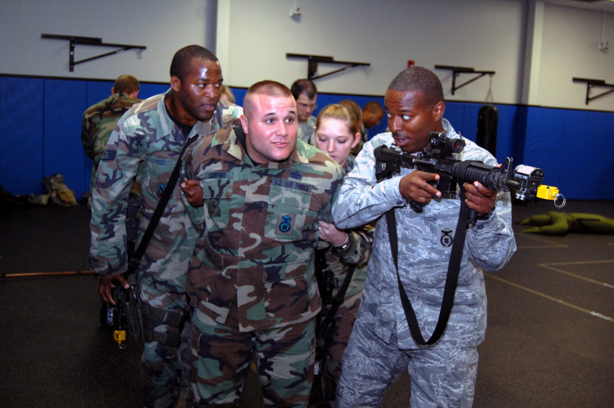 Students in the Air Force Phoenix Warrior Training Course learn close quarters combat tactics during a class session in the U.S. Air Force Expeditionary Center Sept. 22, 2008, on Fort Dix, N.J.  Phoenix Warrior, taught by the center's 421st Combat Training Squadron, is a security forces functional pre-deployment training course focusing on tactics, techniques and procedures unique to the deployed environment.  (U.S. Air Force Photo/Tech. Sgt. Scott T. Sturkol)
