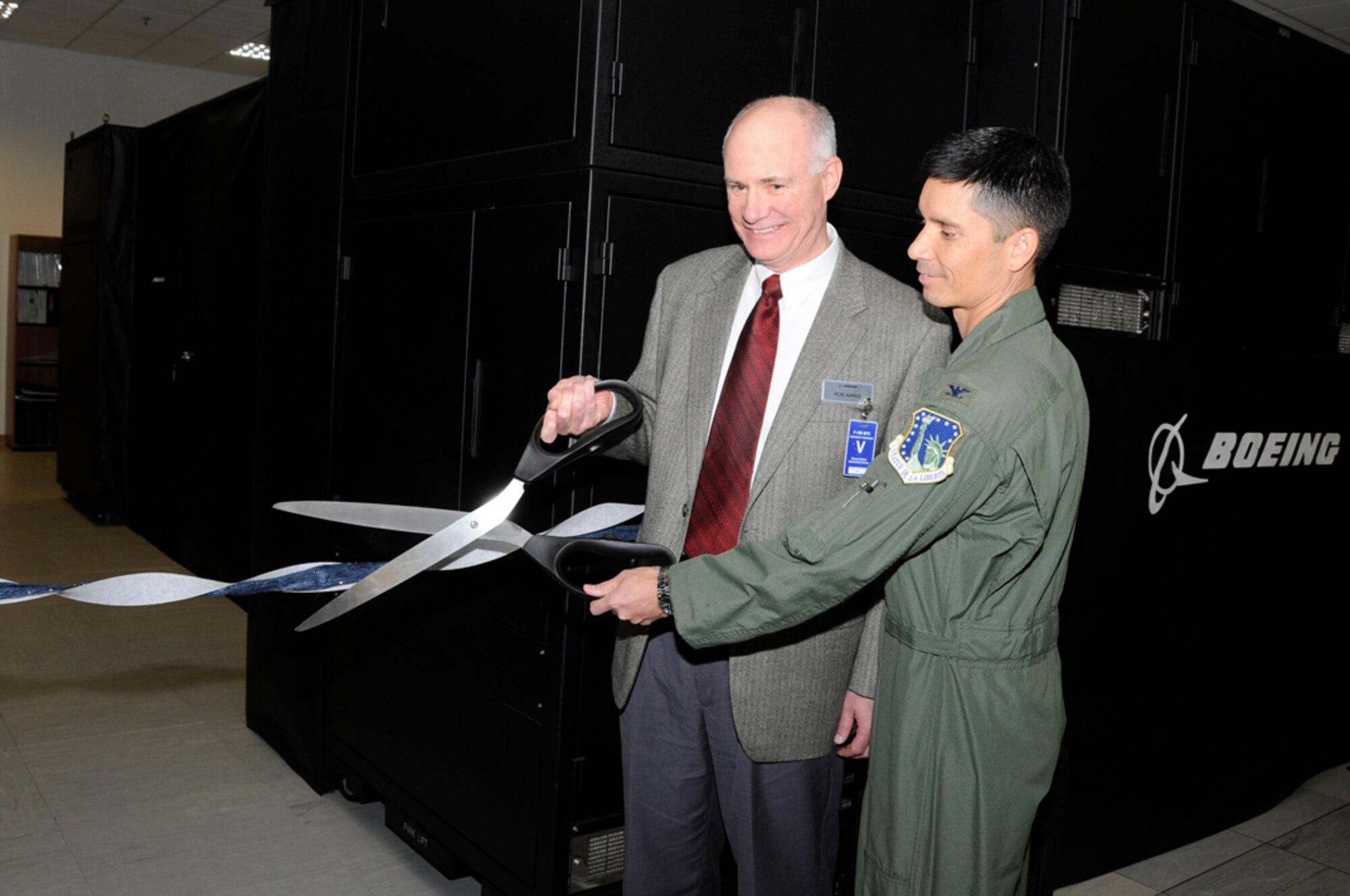Colonel John Quintas, 48th Operations Group commander, and Ron Aarns, director and general manager of operations, Training Systems and Services, Boeing Company, get ready to cut the ribbon at the grand opening of the new Mission Training Center here, Sept. 30. The military training center has four simulators that will allow aircrew members state of the art training to enhance their ability to provide all-weather, day or night, air-to-ground precision combat capability.
