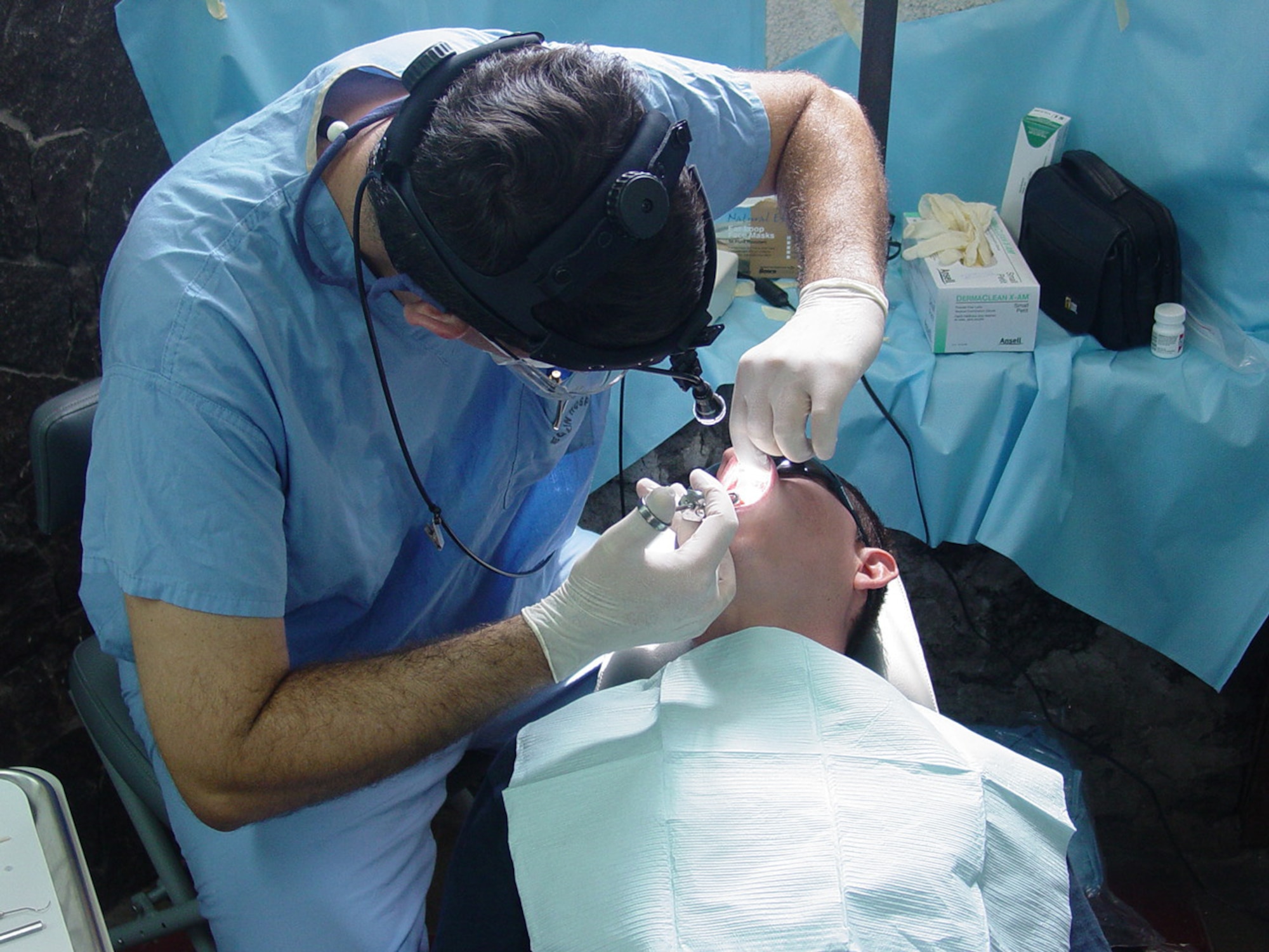 Col. (Dr.) Robert Langsten provides dental care for a patient. He was one of the eighteen dentists and technicians from Barksdale, Lackland, Langley and Eglin Air Force Bases who supported the first all-dental team readiness exercise in Zacatecoluca, El Salvador Sept. 6-20. (courtesy photo)                                                            