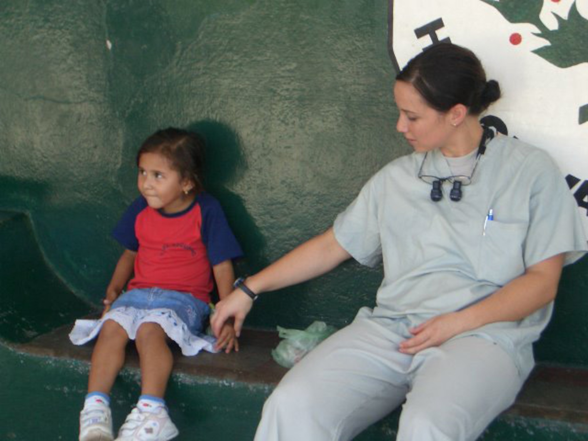 EGLIN AIR FORCE BASE, Fla. -- Dr. (Capt.) Heather Tellez, talks to a patient after a dental procedure.  Dr. Tellez is a dentist from Langley AFB, Va., who was part of the first all-dental team participated in a readiness exercise in Zacatecoluca, El Salvador. Eighteen dentists and technicians from Barksdale, Lackland, Langley and Eglin Air Force Bases supported the exercise Sept. 6-20. (courtesy photo) 